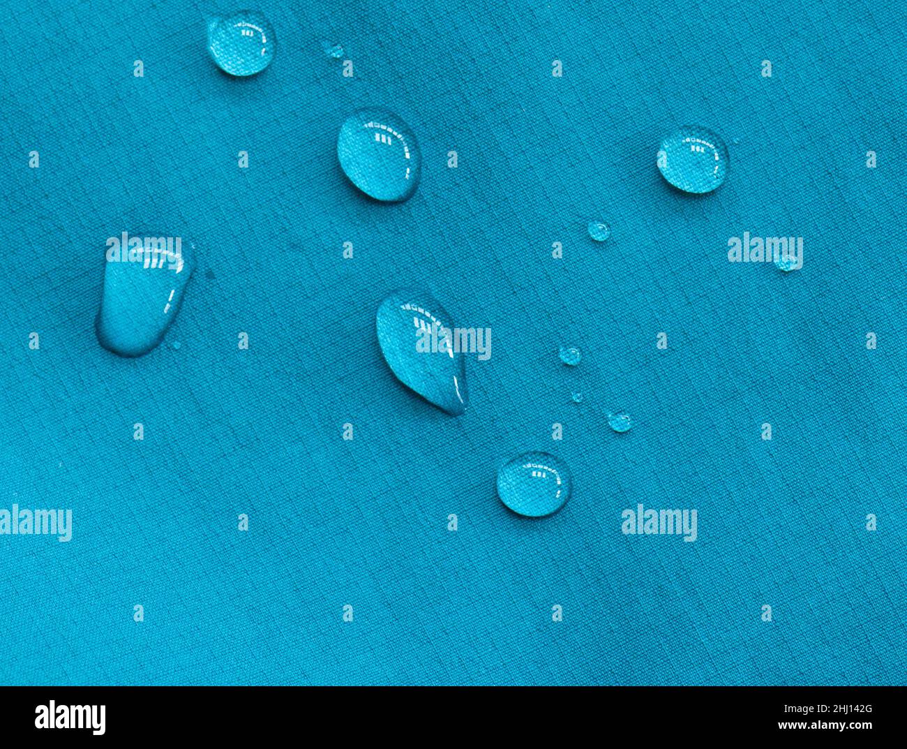 drops of water on waterproof gore-tex fabric on walking jacket demonstrating hydrophobic effect Stock Photo