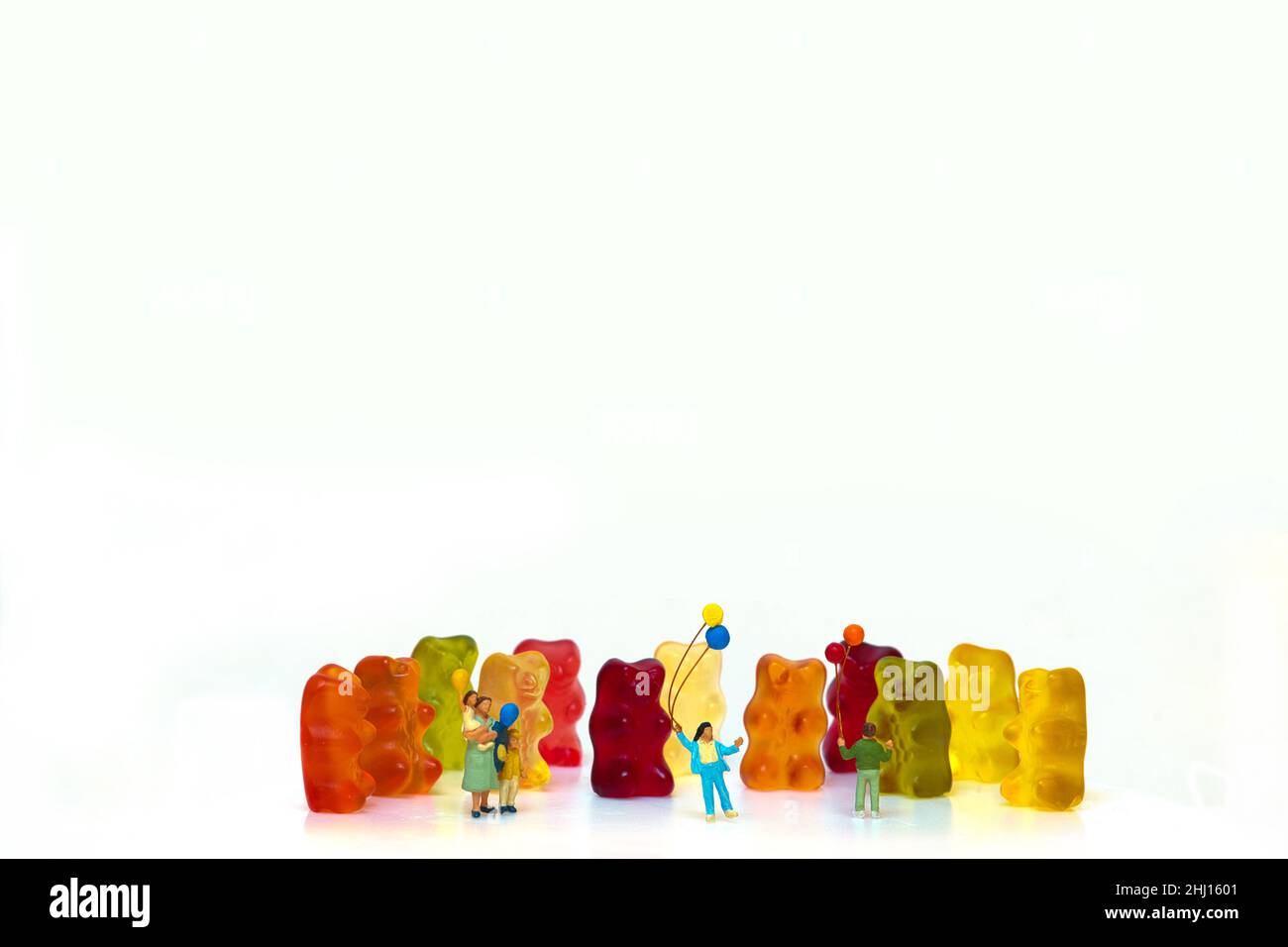 happy children in front of colorful gummy bears Stock Photo