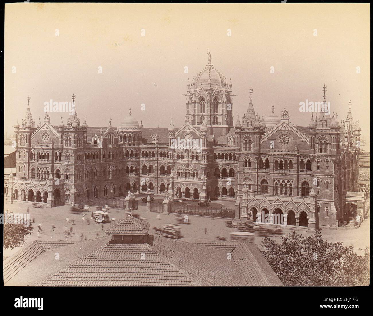 [Victoria Terminus Building, Mumbai] 1860s–70s Unknown Frederick W. Stevens designed this building for the Great Indian Peninsular Railway, to serve as its main train station in Bombay. The style combines the Venetian Gothic popular in England at the time with elements of Indian architecture, and is built in the local red sandstone. A thirteen-foot personification of Progress, raising her arm toward the skies, tops the central dome. The Terminus opened in 1887 in time to celebrate Queen Victoria's Golden Jubilee.. [Victoria Terminus Building, Mumbai]  264519 Stock Photo