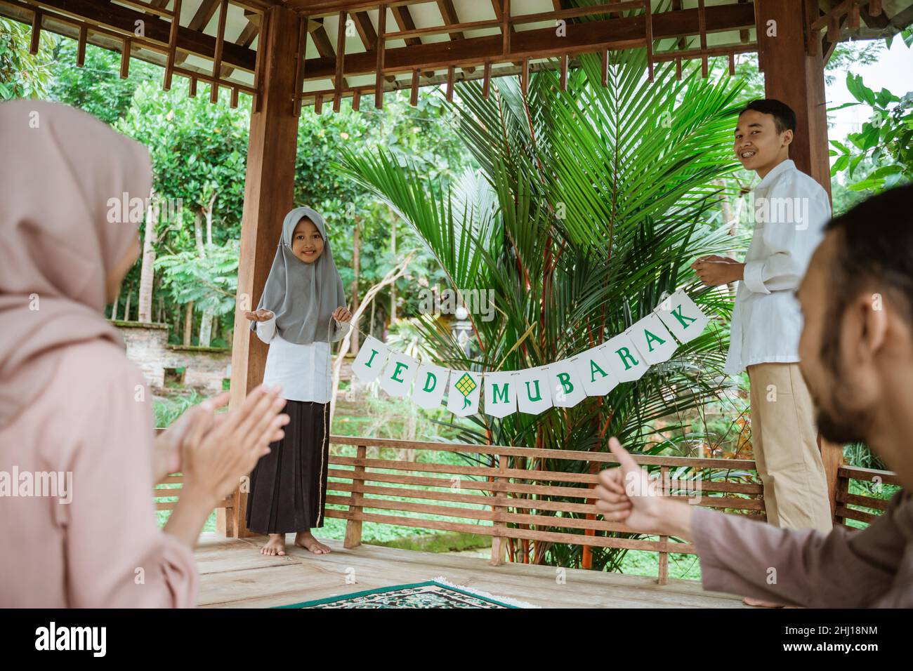 the children put up a flag chain decoration in gazebo Stock Photo