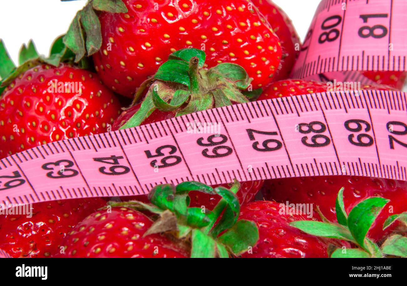 Red fresh strawberry with tape measure isolated on the white Stock ...
