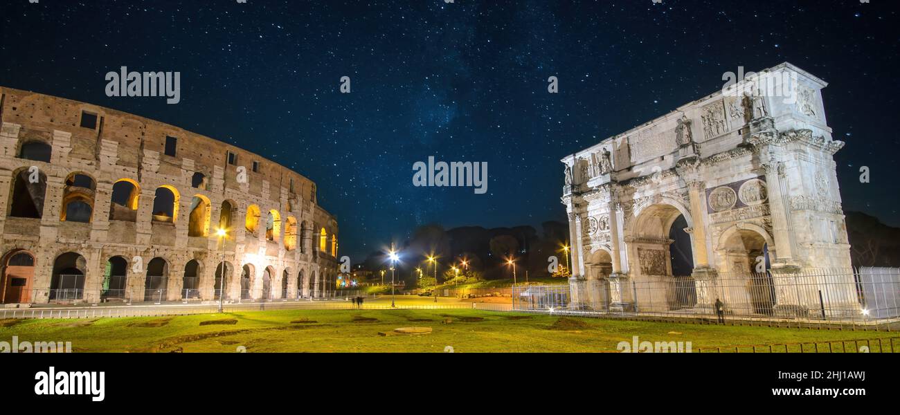 Colosseum (Coliseum) in Rome (Roma), Italy and Arch of Constantine at night. Panorama of Flavian Amphitheatre and Arco de Constantino Stock Photo