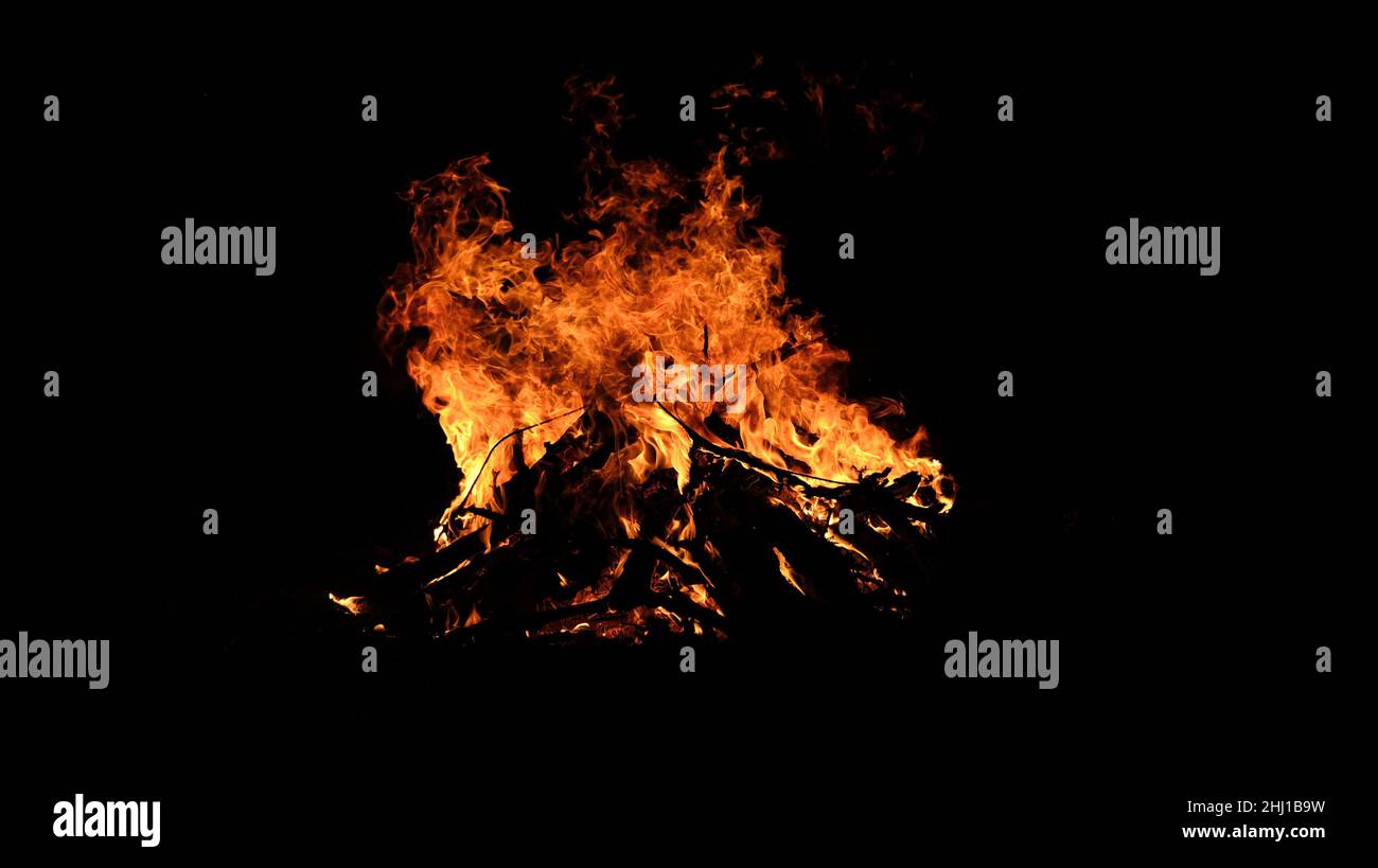 Big campfire blazing in the night outdoors Stock Photo