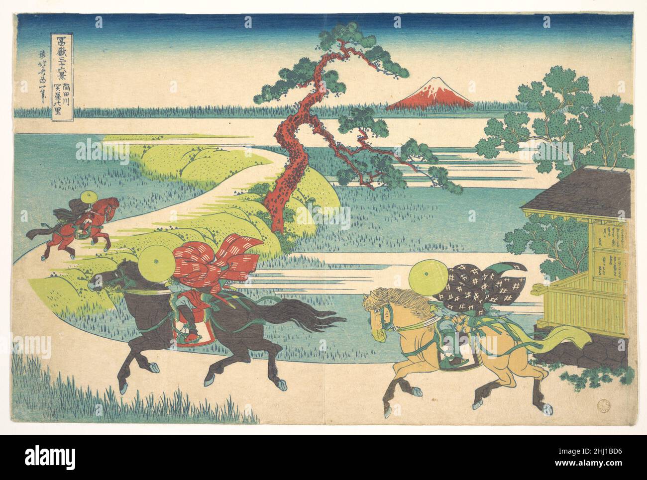 Sekiya Village on the Sumida River (Sumidagawa Sekiya no sato), from the series Thirty-six Views of Mount Fuji (Fugaku sanjūrokkei) ca. 1830–32 Katsushika Hokusai Japanese The speed and urgency of the galloping horsemen stand in contrast to the solitary and static image of Fuji capping the horizon like an omniscient observer and marking that which is eternal. The raised road that winds into the depths of the print directs our gaze to the mountain, as do the trees that function as a framing device.. Sekiya Village on the Sumida River (Sumidagawa Sekiya no sato), from the series Thirty-six Views Stock Photo
