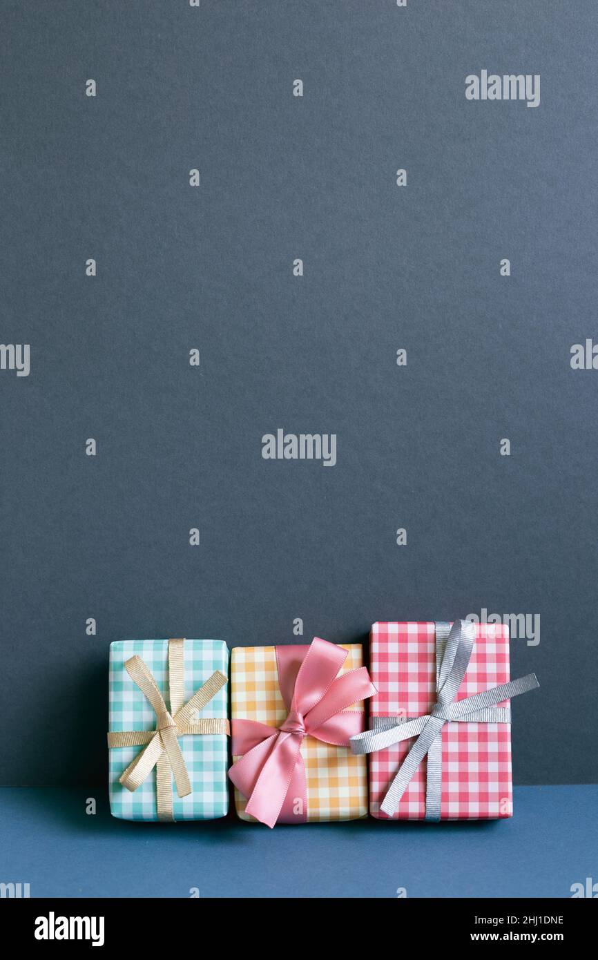 Colorful gift boxes on table. navy blue wall background Stock Photo