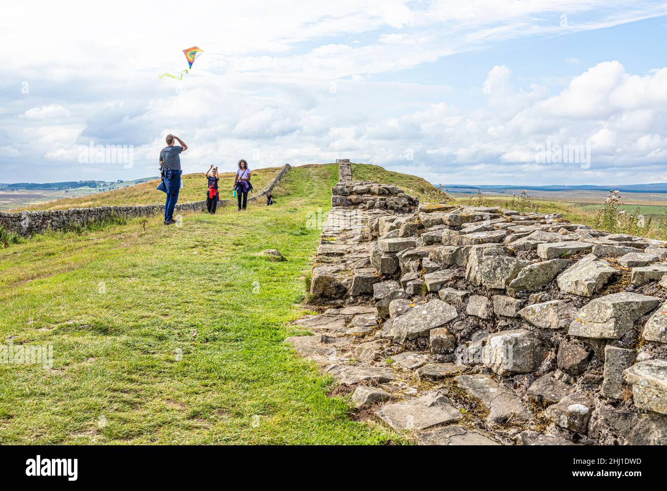 Flying a kite beside Hadrians Wall at Caw Gap, Shield on the Wall, Northumberland UK Stock Photo
