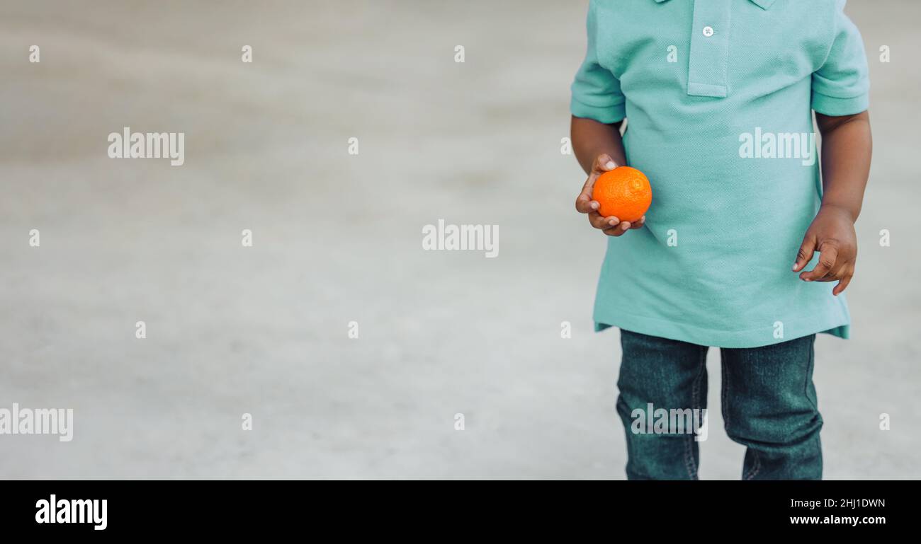 A cute one year old toddler almost preschool age African-American boy