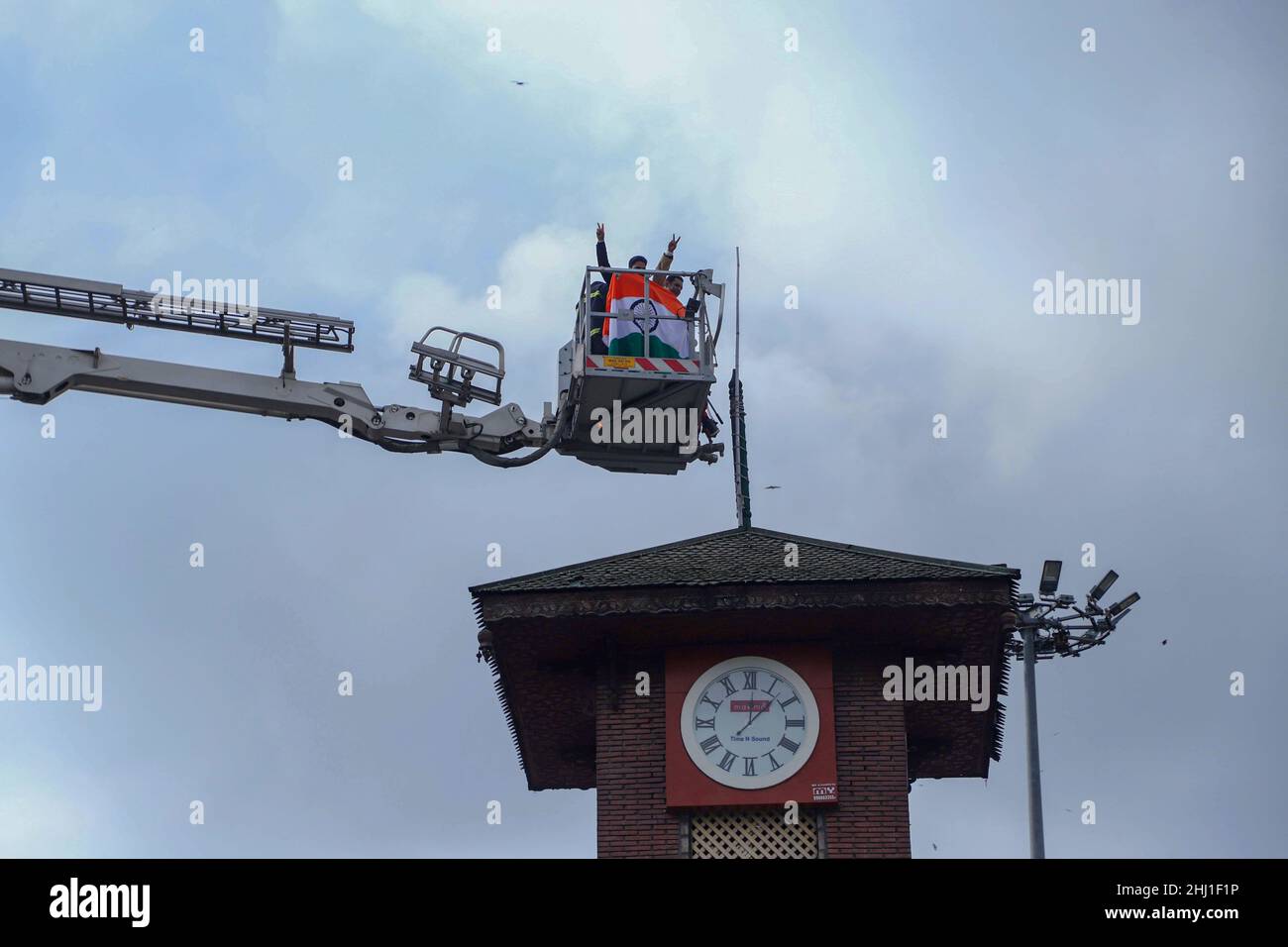 Indian activist place an Indian flag at the top of a clock tower in Lal Chowk to celebrate India's 73rd Republic Day in Srinagar on January 26, 2022. (Photo by Faisal Bashir/INA Photo Agency/Sipa USA) Stock Photo