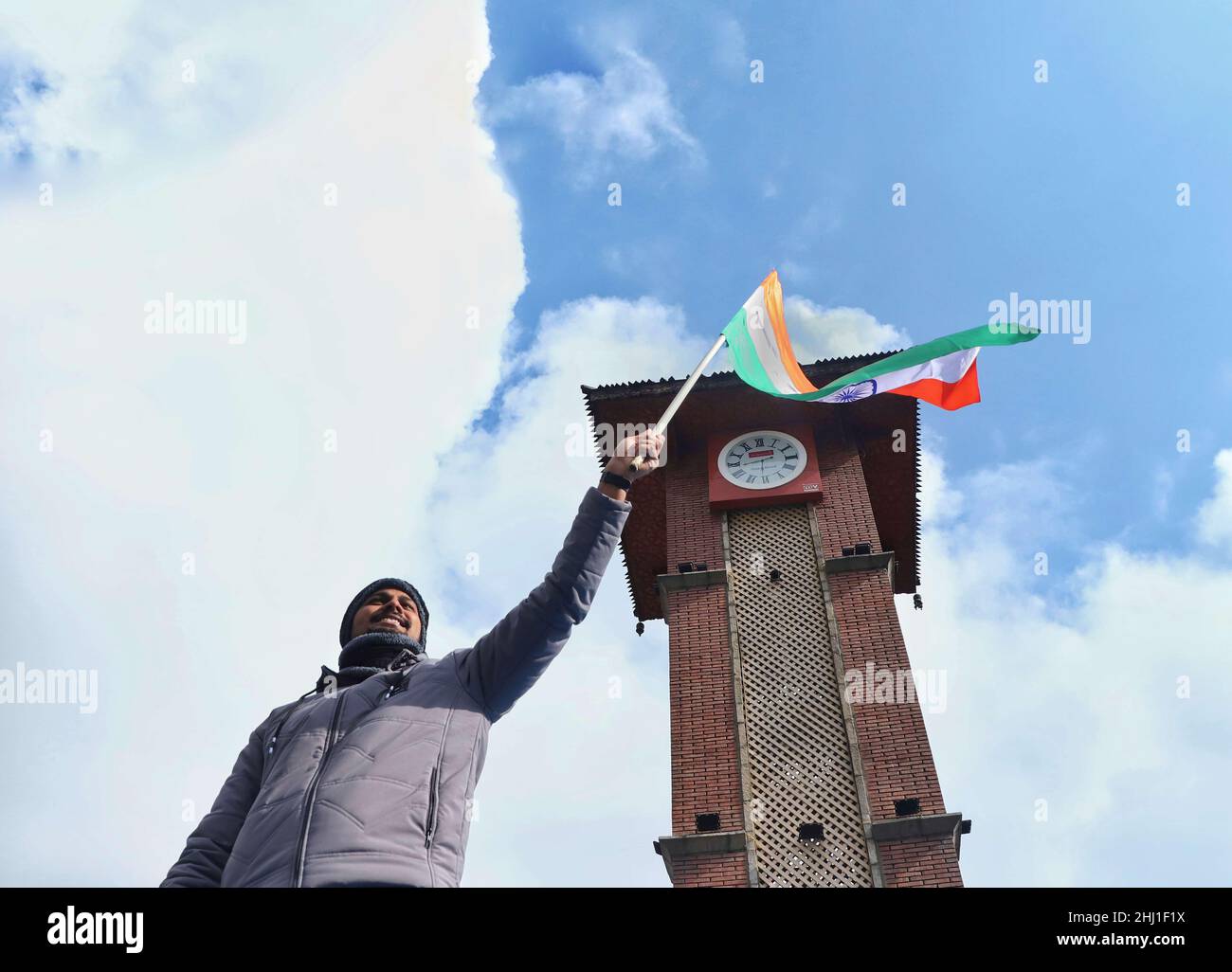 A Indian activist hold an Indian flag near a clock tower in Lal Chowk to celebrate India's 73rd Republic Day in Srinagar on January 26, 2022. (Photo by Faisal Bashir/INA Photo Agency/Sipa USA) Stock Photo
