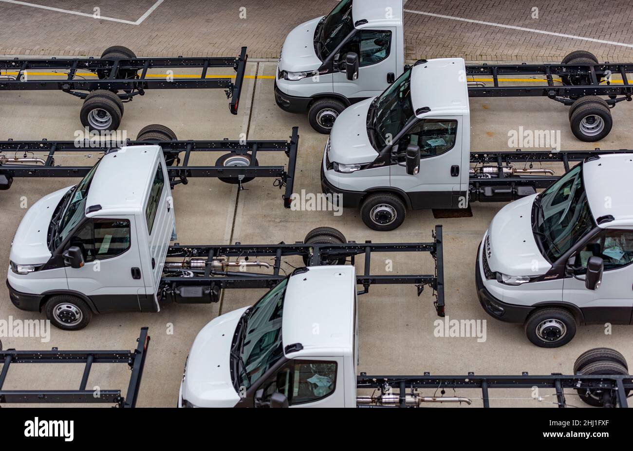 vans cabs and chasis awaiting export in a car park at the port of southampton docks uk, vehicles on dockside waiting shipping abroad by carriers. Stock Photo