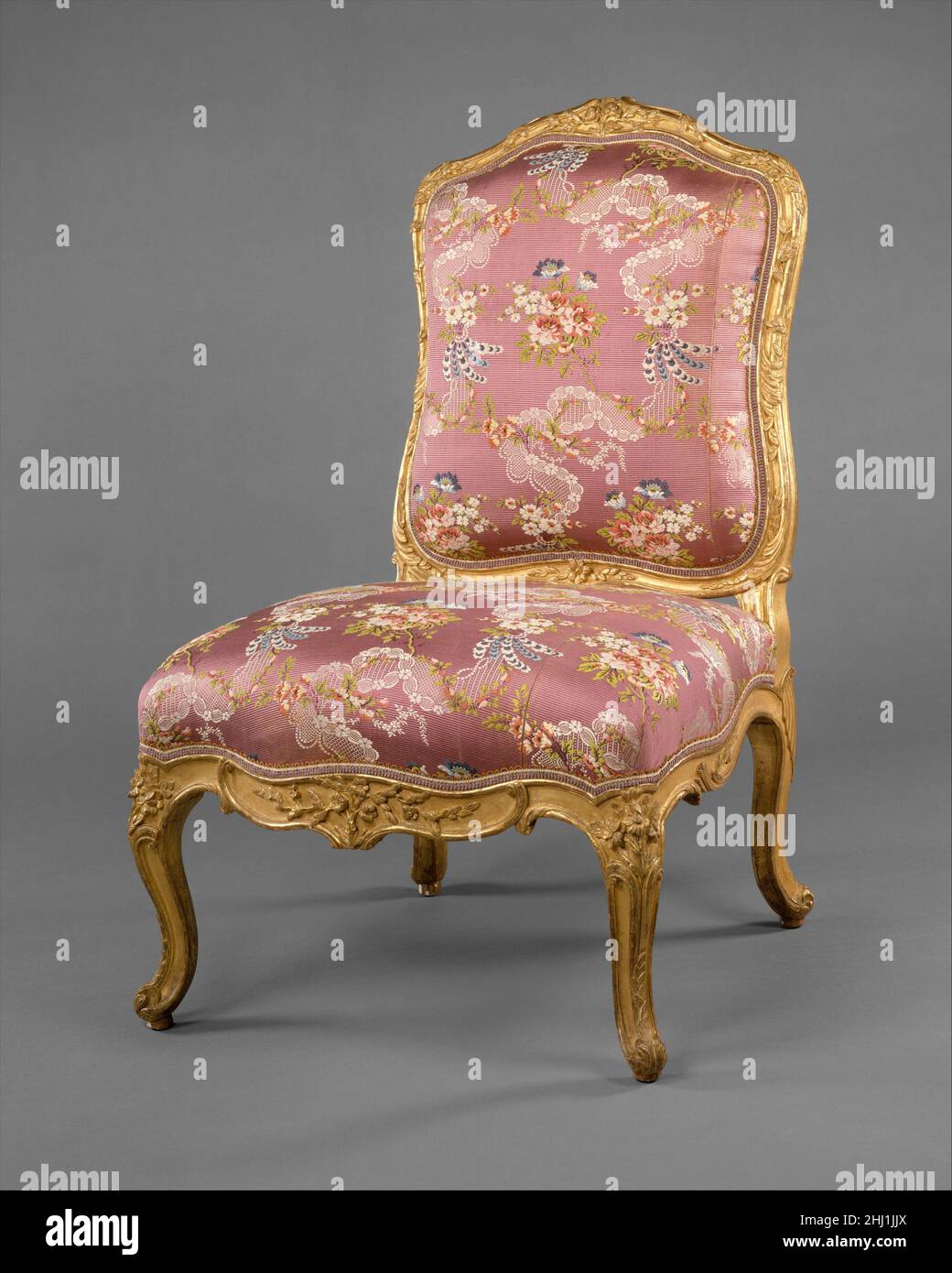 Pair of side chairs (chaises à la reine) ca. 1752–60 Michel Gourdin The top rail of the back and front rail of the seat are carved with three flowers flanked by branches of flowers and leaves. Both Michel and Jean-Baptiste Gourdin used the motif of a flower at each front corner above a split stem running down the fore edge of the front leg with an acanthus leaf on the foot. Other chairs by Michel Gourdin are in the Louvre, the Bouvier Collection in the Musée Carnavalet, Paris; the Wallace Collection, London; Windsor Castle; and the collection of Mr. and Mrs. Charles Wrightsman, New York.[Bill Stock Photo