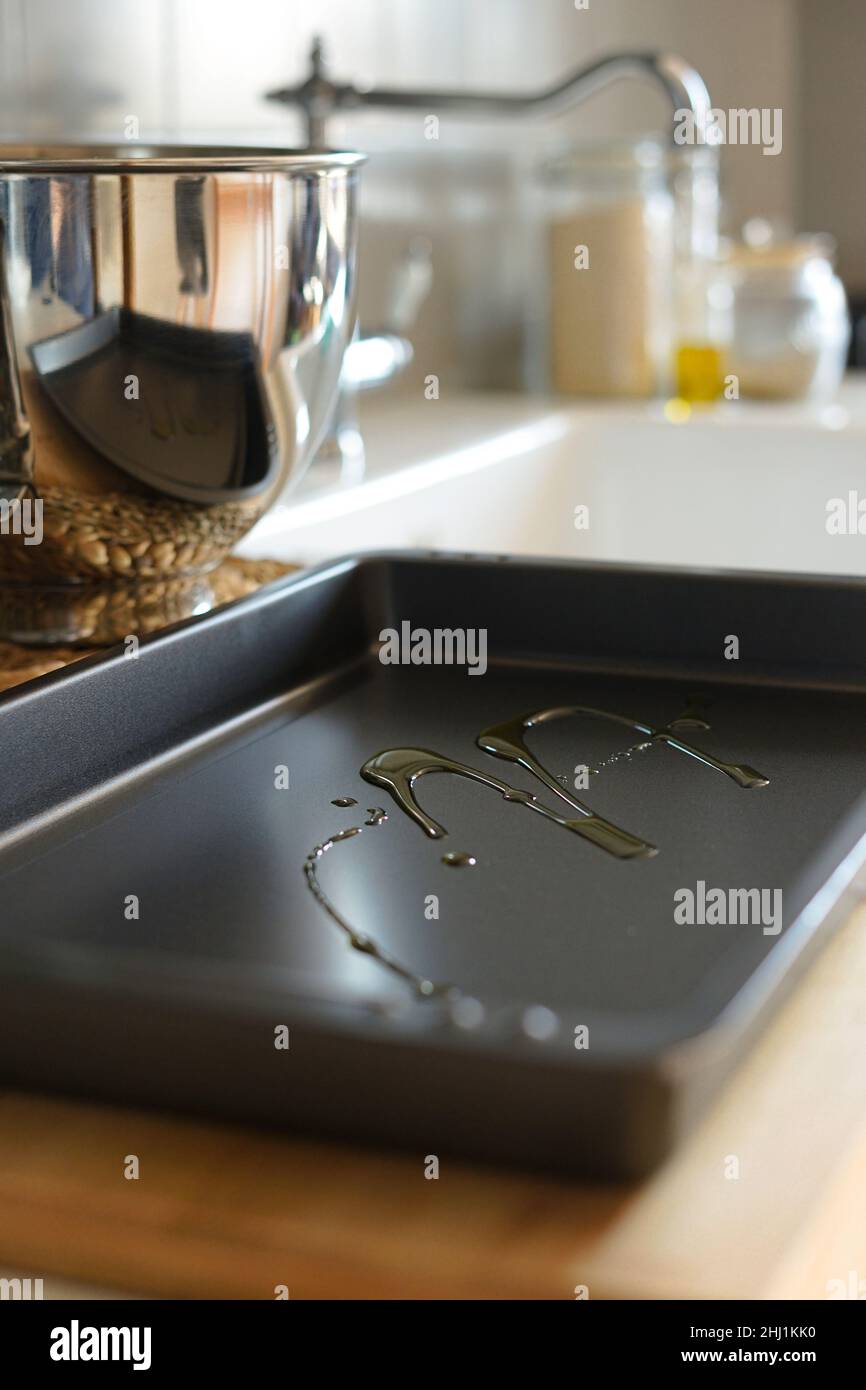 Dark new and clean baking tray with olive oil inside Stock Photo