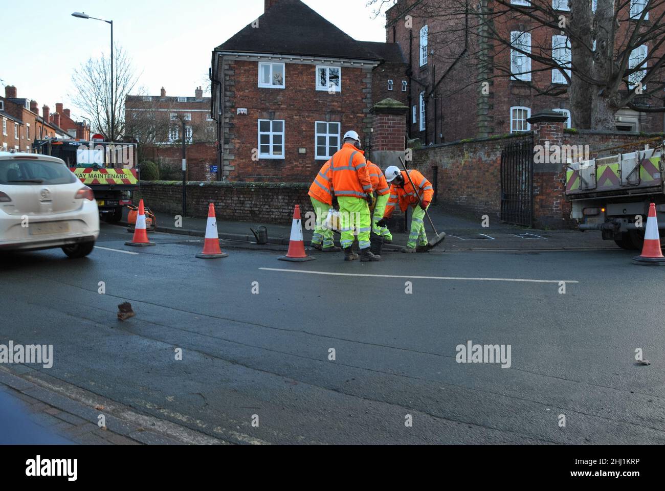 Men in hi viz clothing working on the road Stock Photo