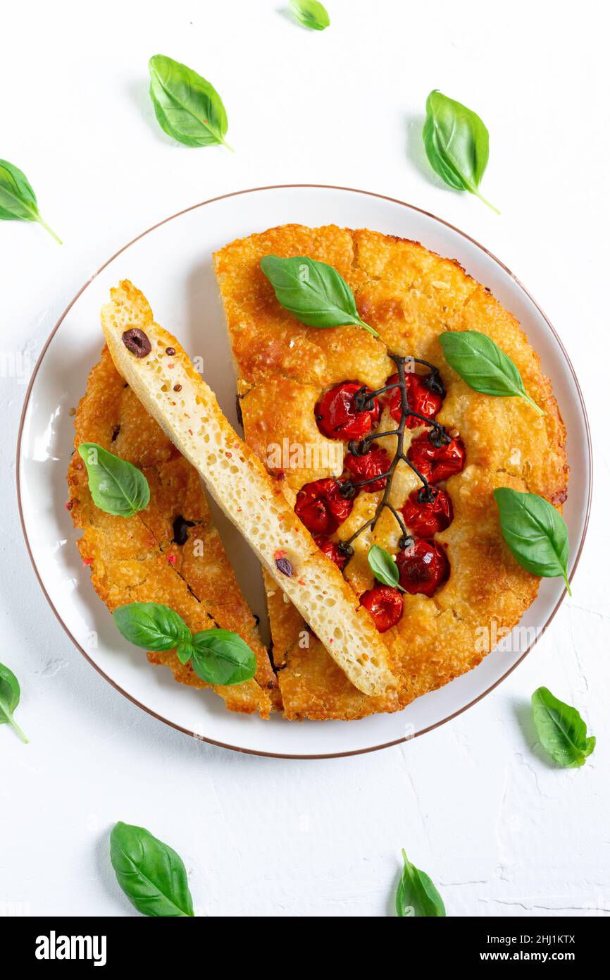 Freshly baked focaccia with cherry tomatoes on a plate Stock Photo