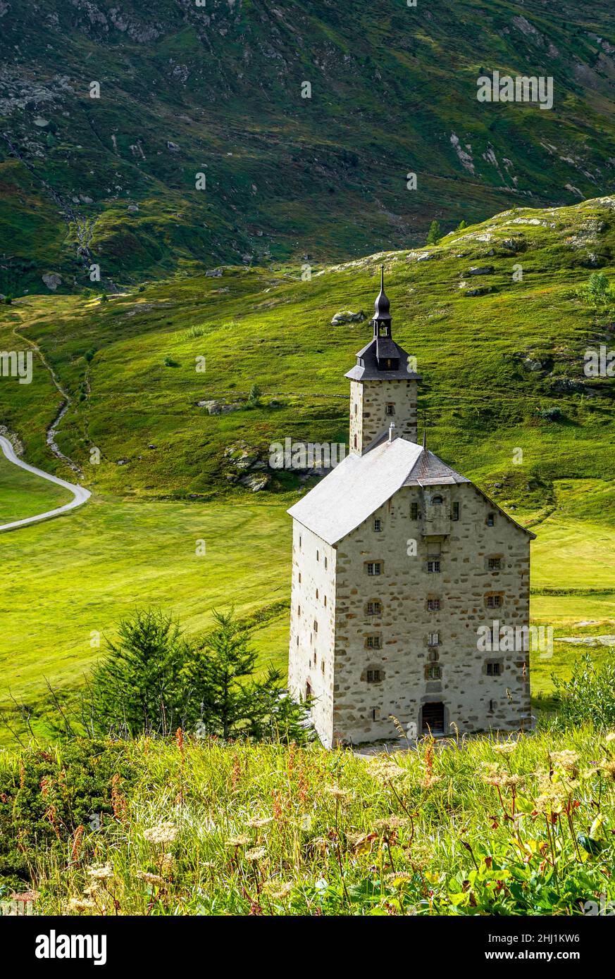 old stone monastery with a green meadow in the background Stock Photo