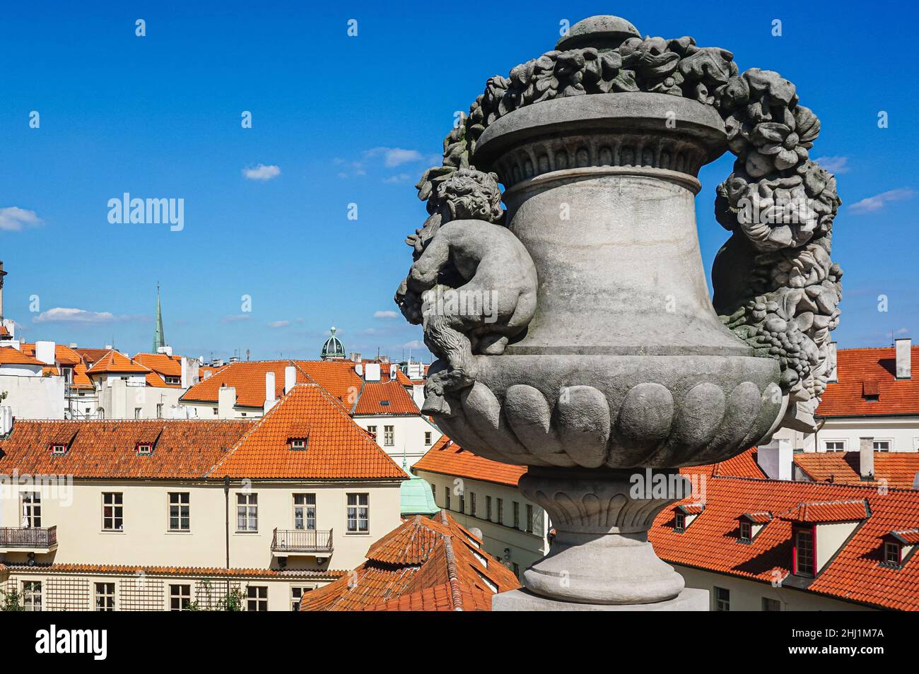 The angel statue's butt against the city's rooftops Stock Photo