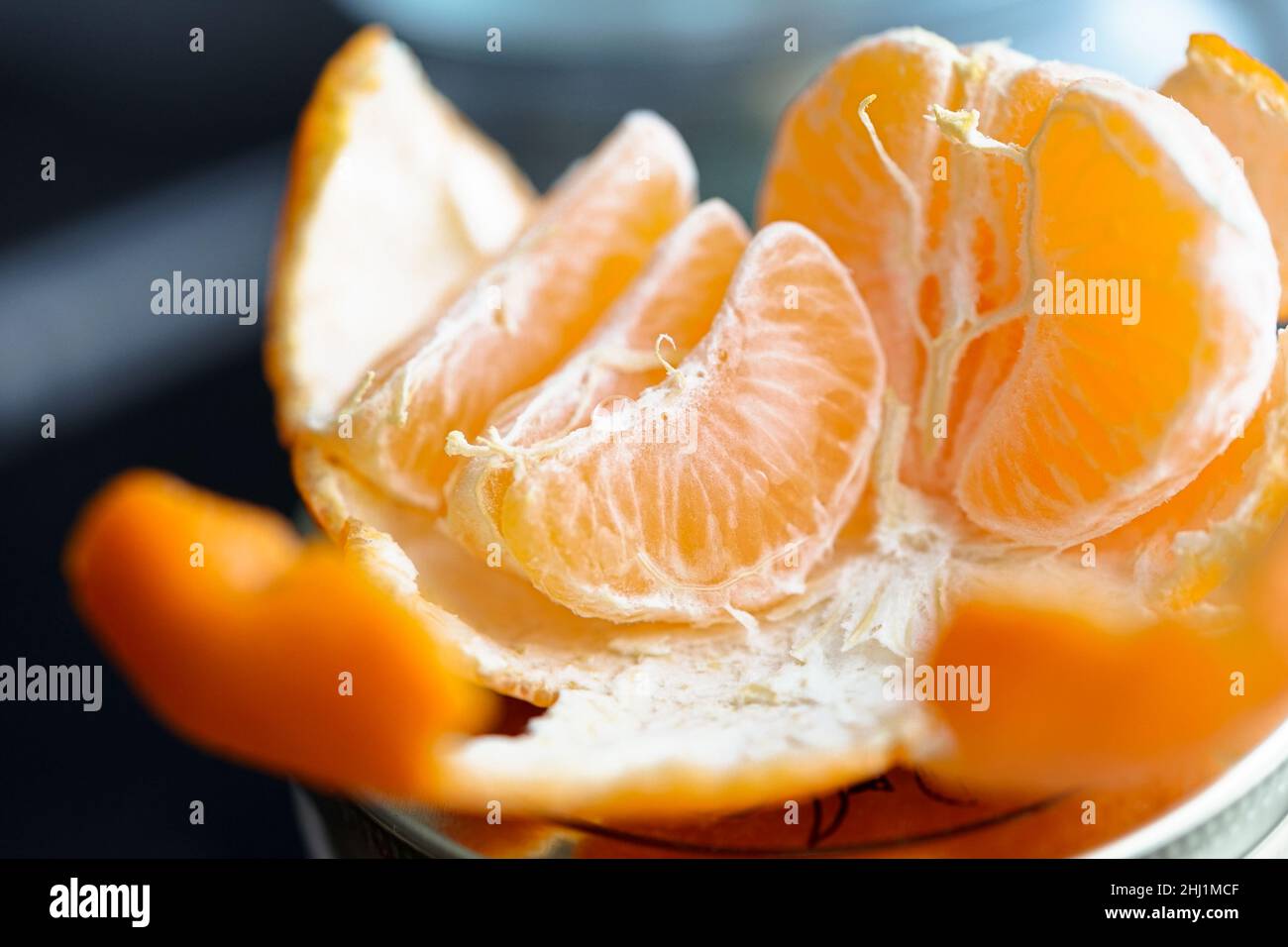 Peeled and sliced into bright tangerines Stock Photo