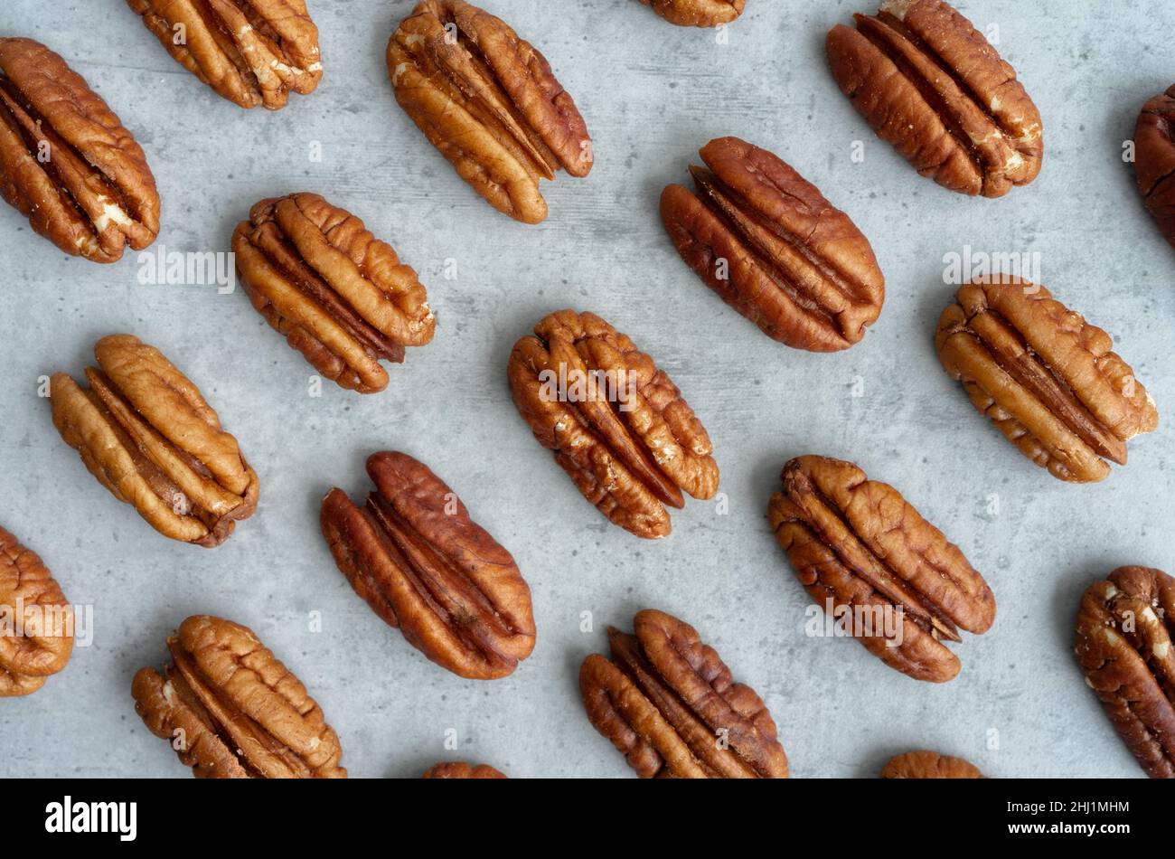 Pecan pattern on gray background, close-up Stock Photo
