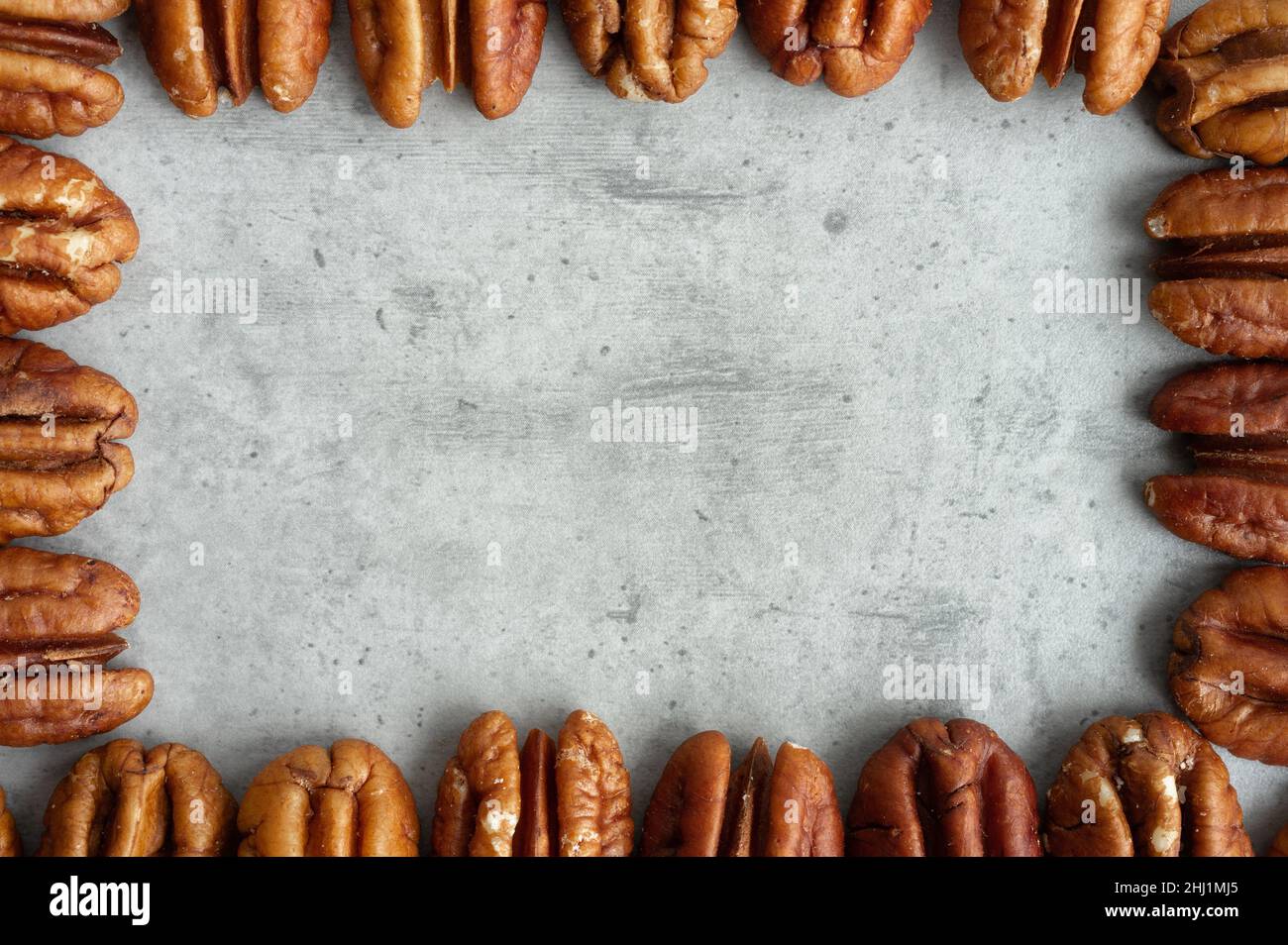 Pecan frame on gray background, top view, close-up Stock Photo