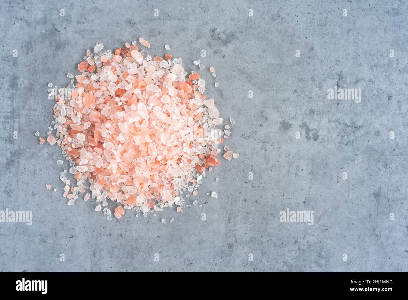 Pink Himalayan salt piled on a gray background Stock Photo