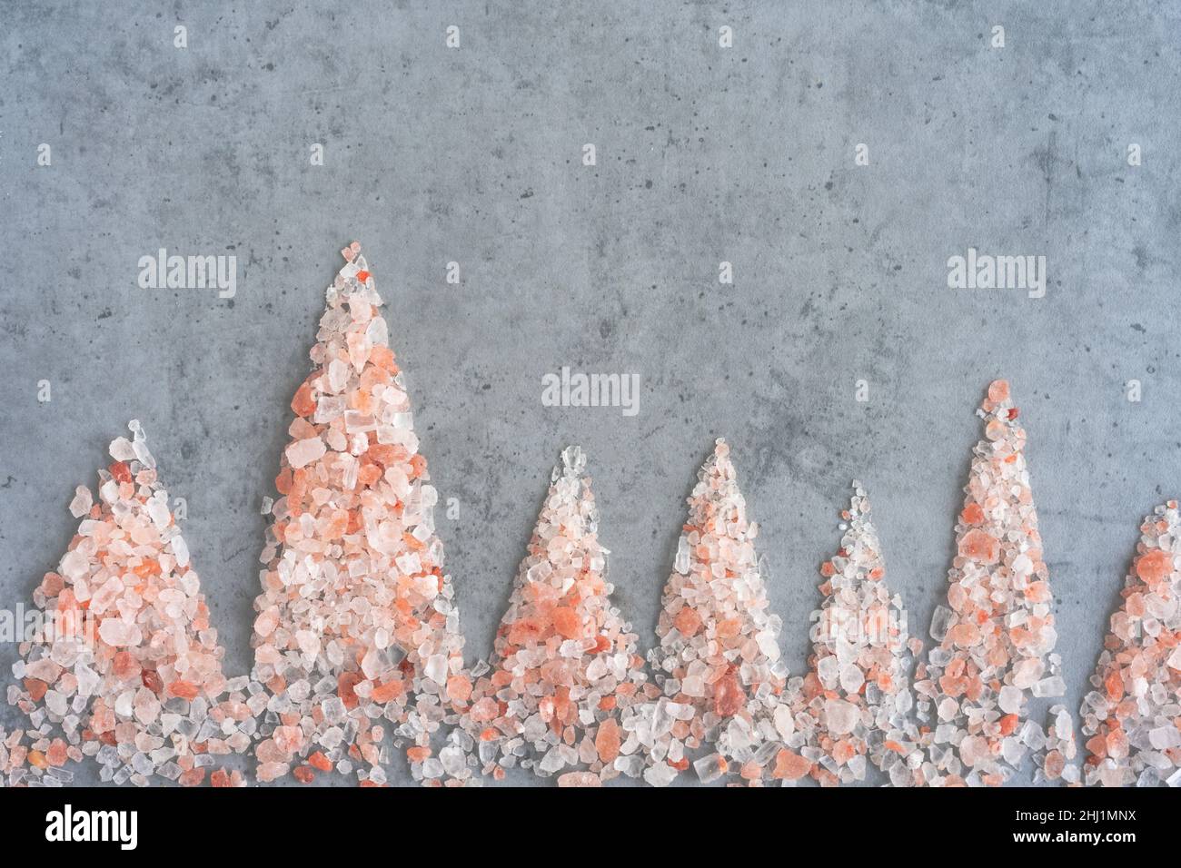 Himalayan salt in the form of mountains on a gray background Stock Photo