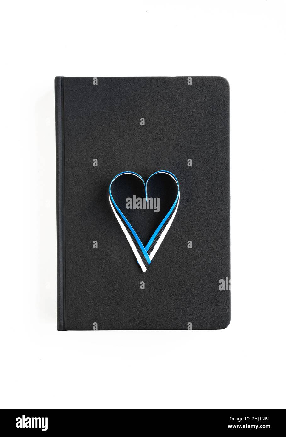 Black notepad on white background with a heart in the color of the Estonian flag Stock Photo