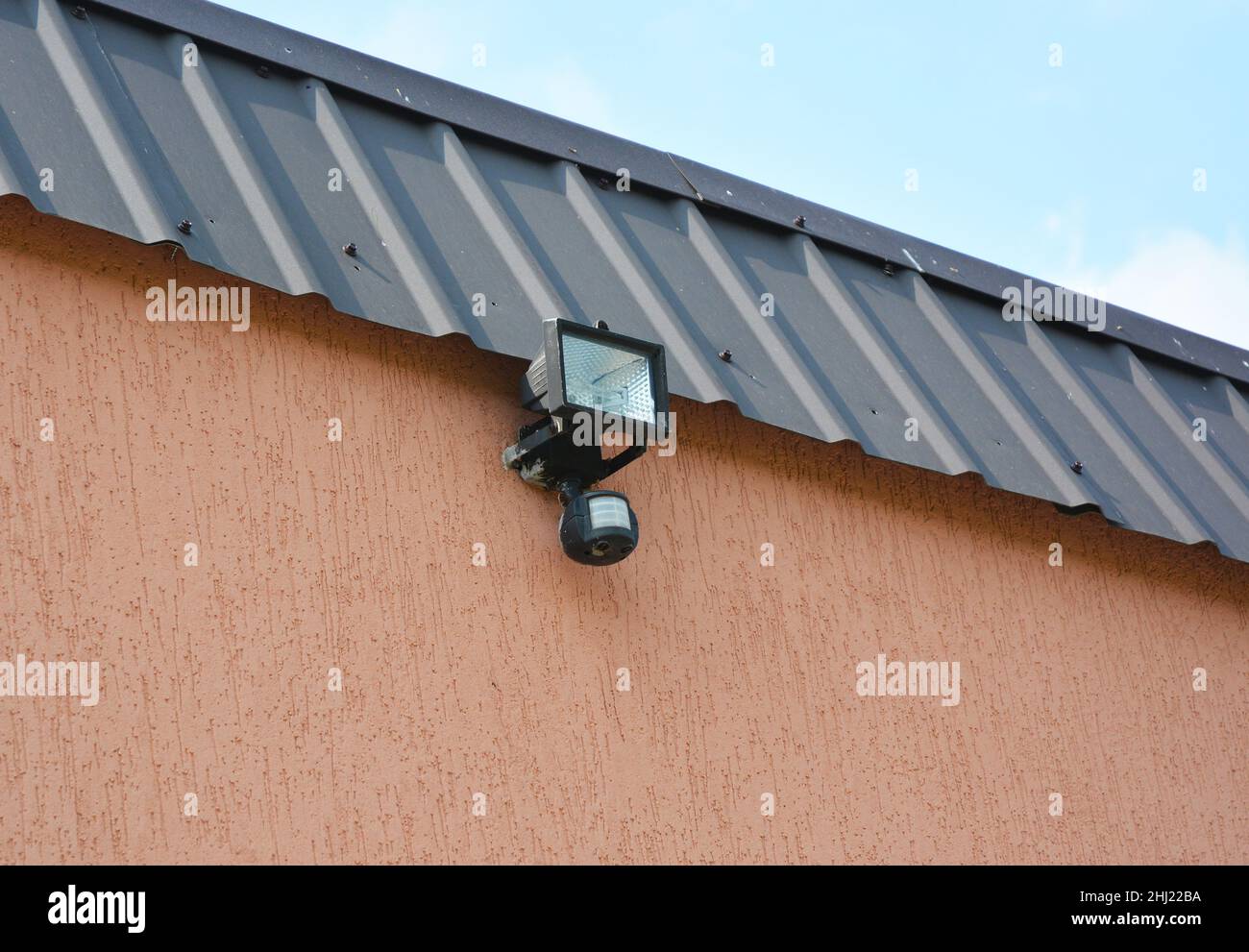 Motion Flood LED Light. Installing Motion Detector Lighting. Close up