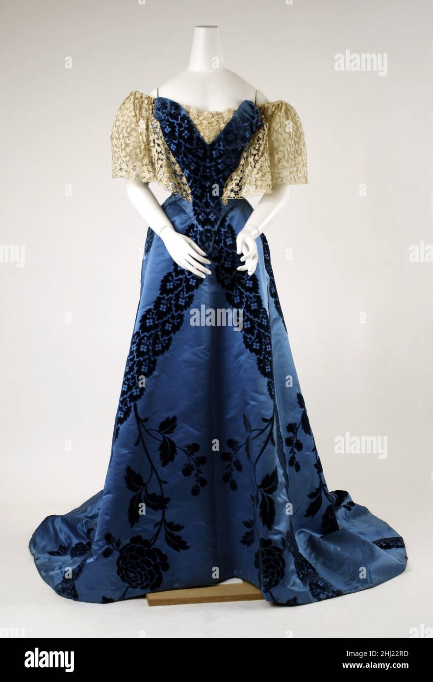 Evening dress 1898–1900 House of Worth French By the 1890s, Worth was using  large-sized ornament and was increasing simplifying his silhouette. He  created this dress by separating zones of monumental schematic roses