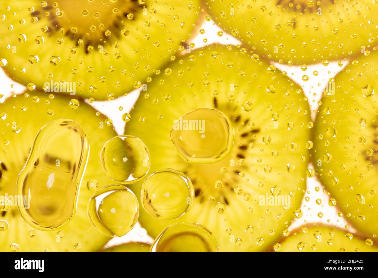 Creative macro food / fruit portrait of succulent Kiwi-Fruit, Kiwifruit, Chinese gooseberry, and water bubbles Stock Photo