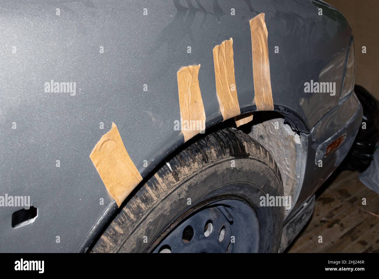 Gray car fender covered with duct tape Stock Photo Alamy
