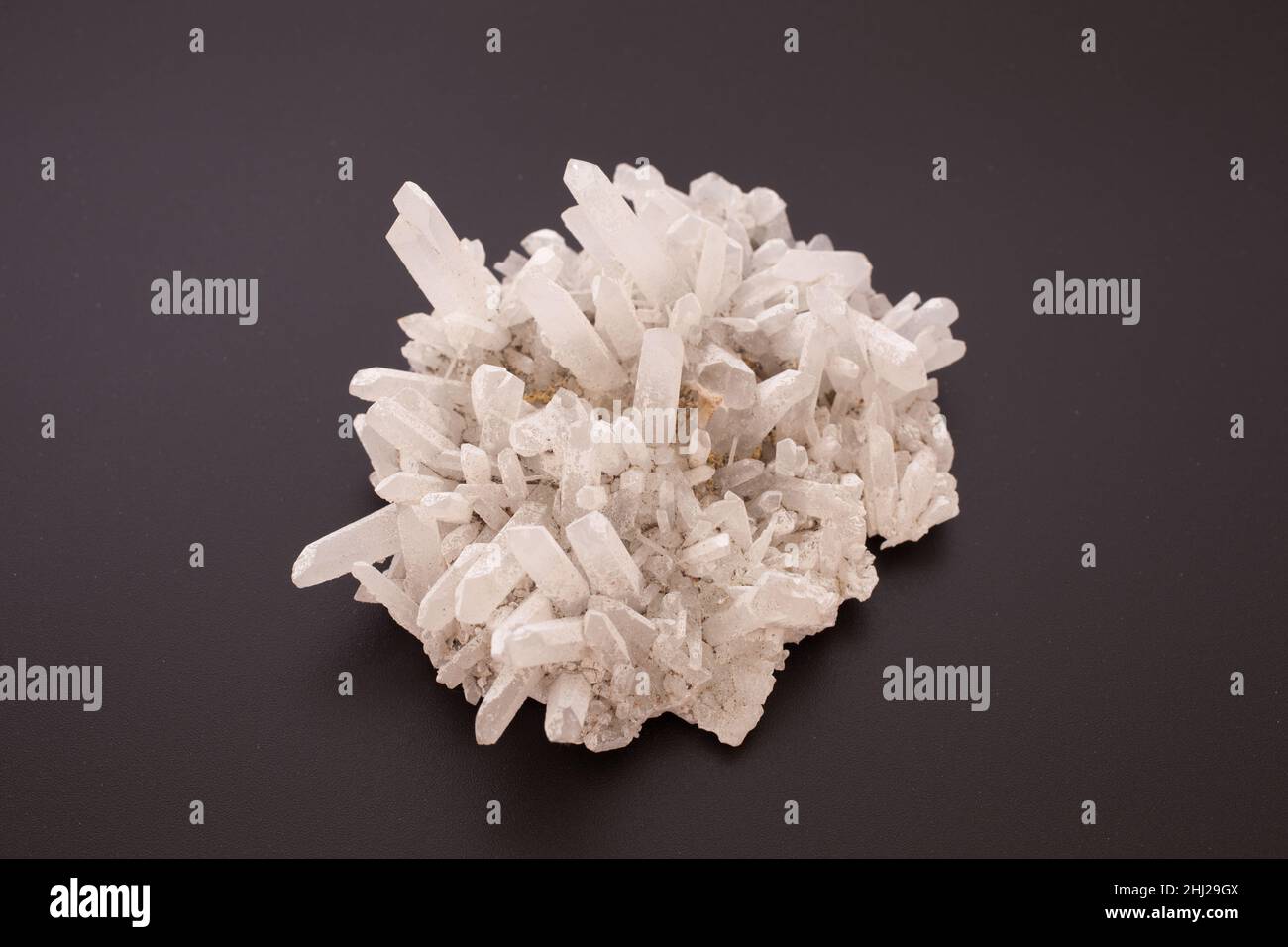 A clear quartz cluster against a black background Stock Photo