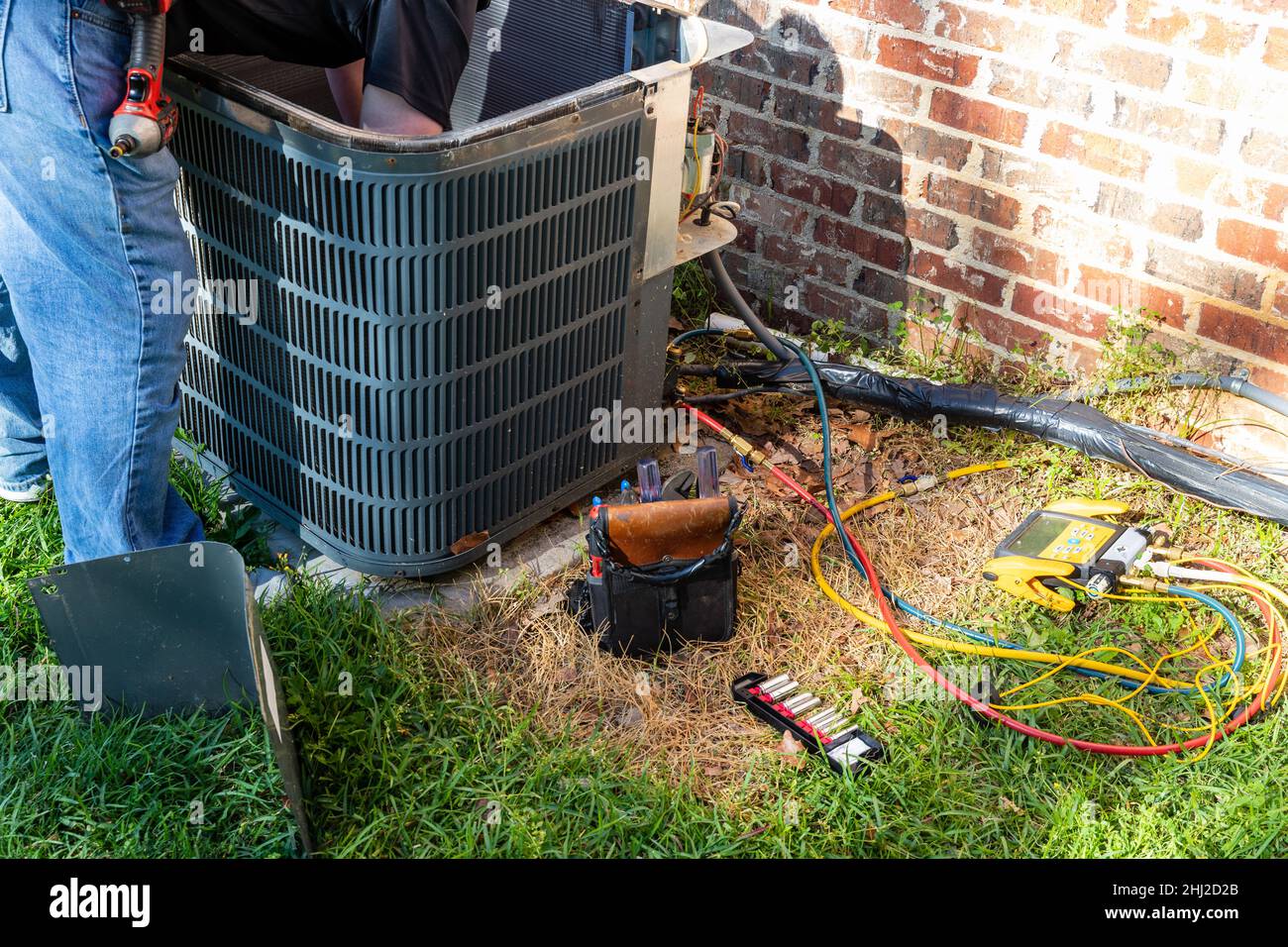 Air conditioner maintenance being performed Stock Photo