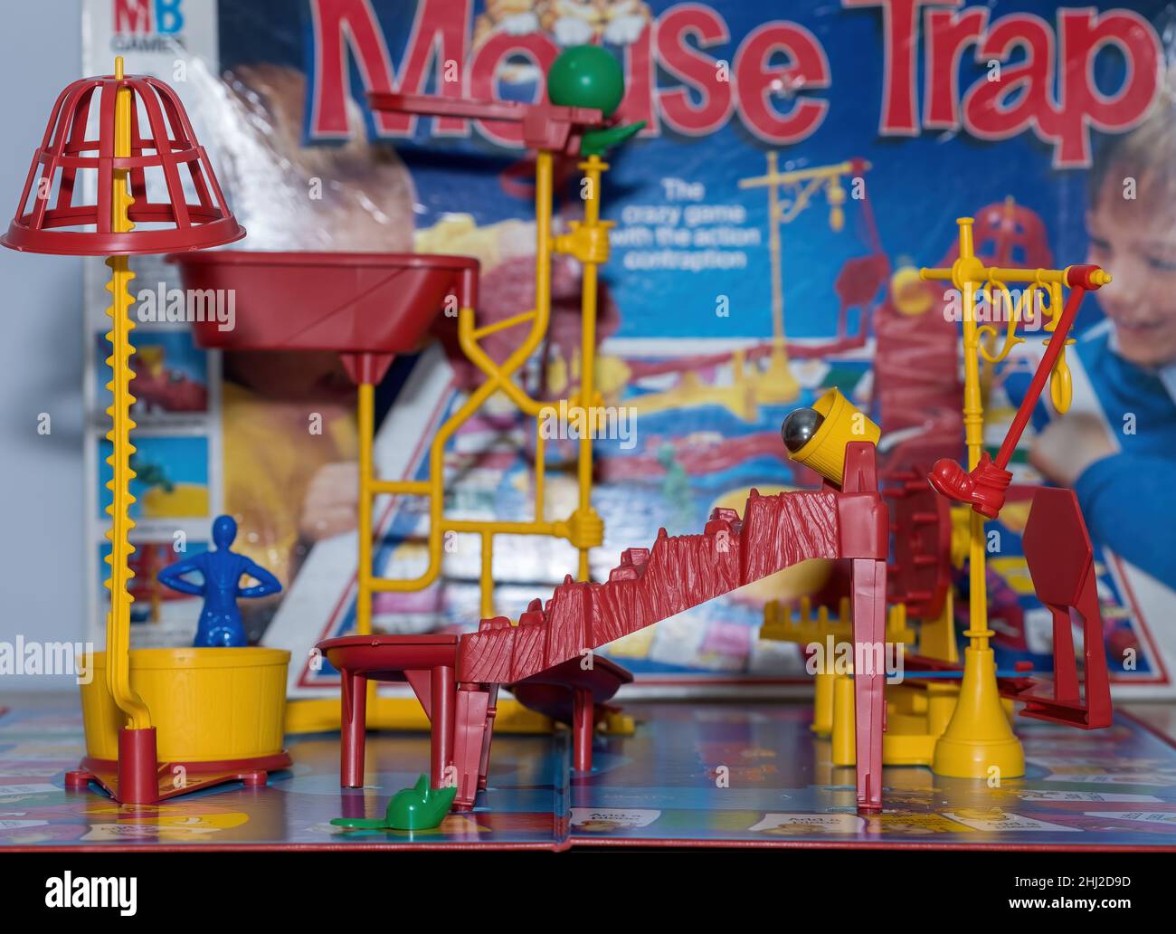 A view of the boot kicking the steel ball out of the bucket, in front of the MB Games box the game comes in. Stock Photo