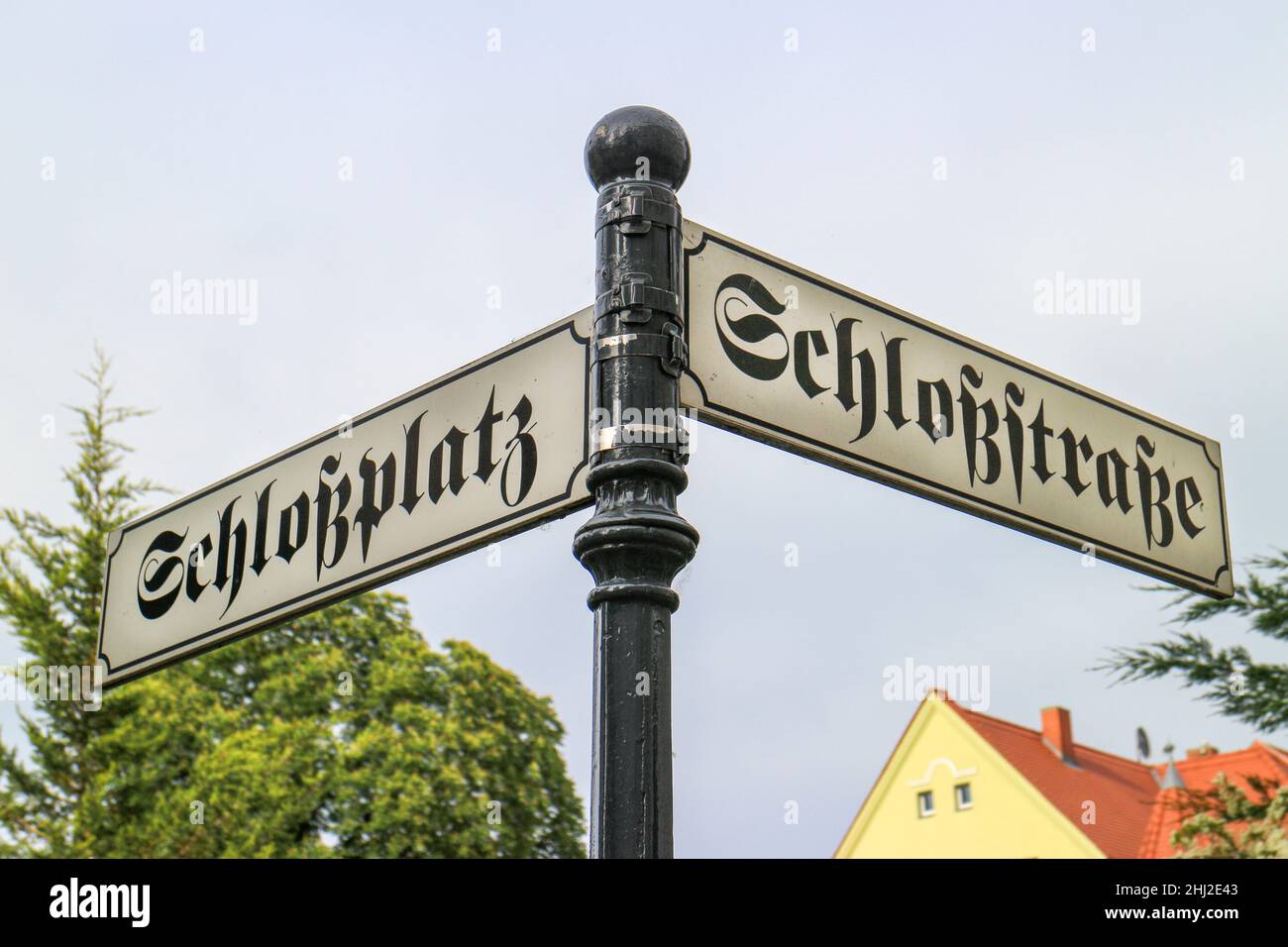 German antique street sign with the street names 'Schloßstraße' and 'Schloßplatz' which translates into 'Castle street' and 'Castle place' in English Stock Photo