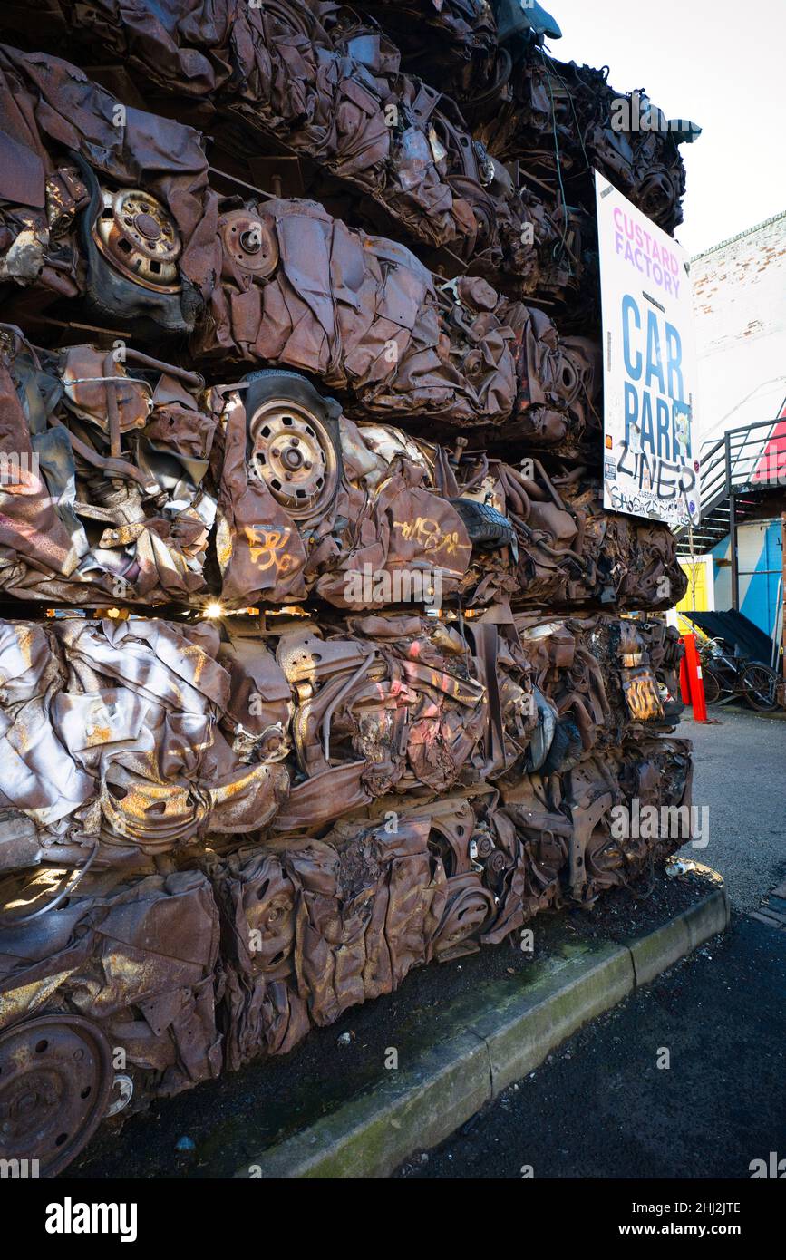 Crushed cars making up a wall at the Custard Factory car park in