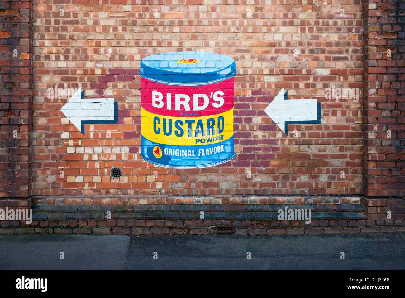Bird's Custard powder tin painted on a brick wall in Digbeth area of Birmingham Stock Photo