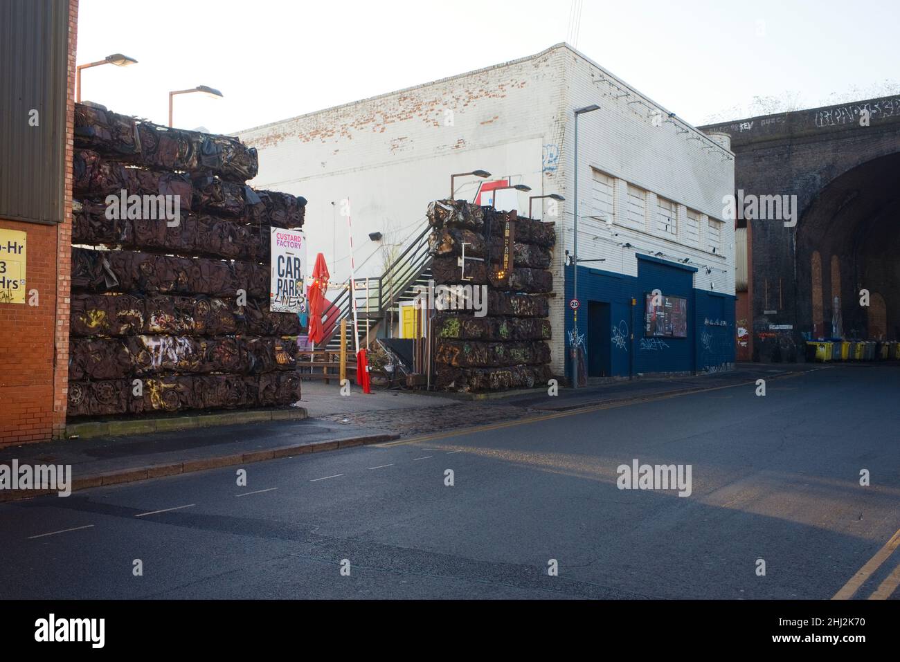 Crushed cars making up a wall at the Custard Factory car park in