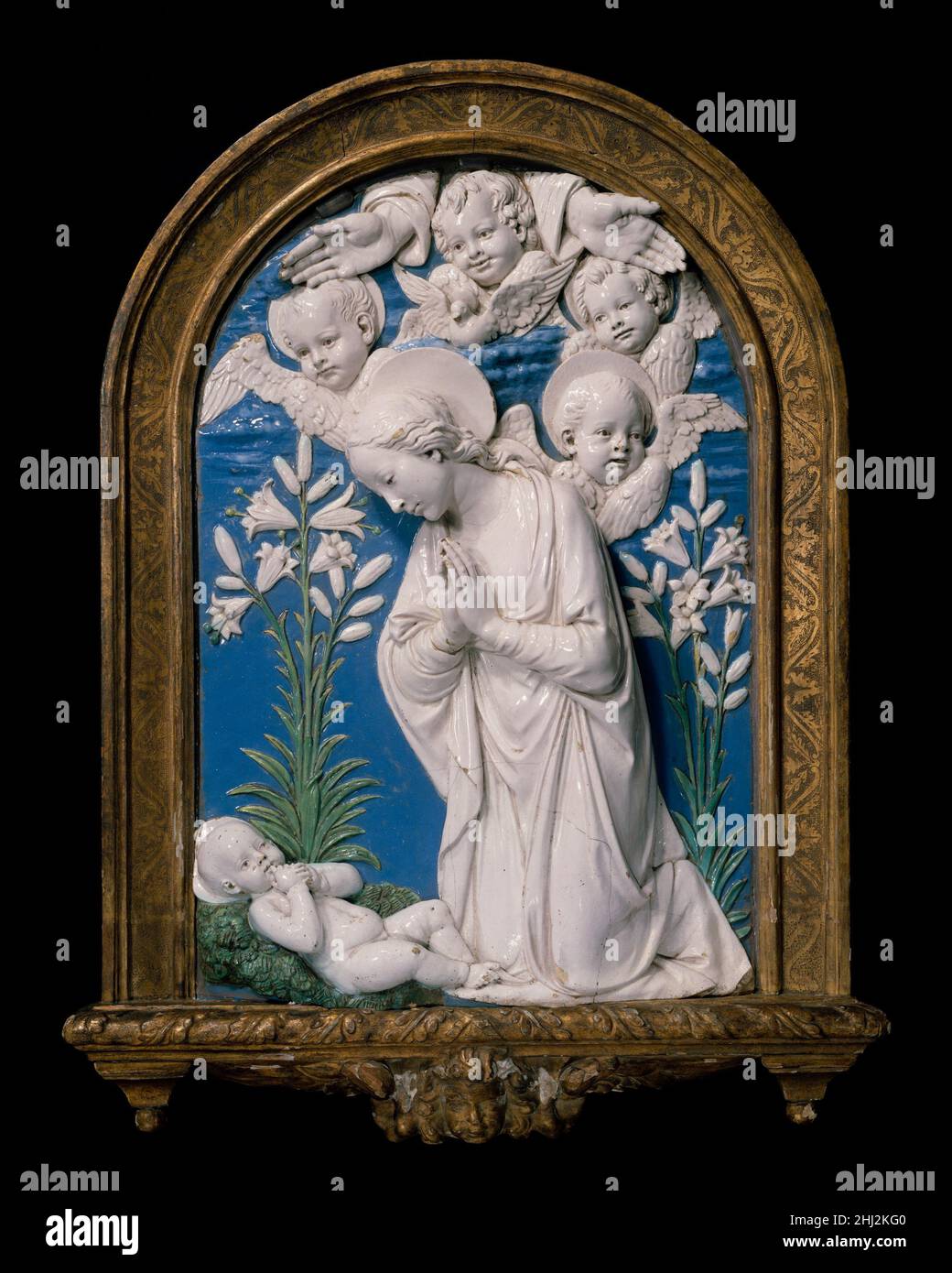 Virgin Adoring the Christ Child after 1479 Workshop of Andrea della Robbia Italian This is a possibly unique variant of several types of variants deriving from the so-called La Verna altarpiece, executed by Andrea del Robbia in 1479 for the Brizi Chapel in the Chiesa Maggiore at La Verna. See also 65.181.24 and 39.186.2. Gilt wood frame not original.. Virgin Adoring the Christ Child. Workshop of Andrea della Robbia (Italian, 1435–1525). Italian, Florence. after 1479. Glazed terracotta. Sculpture Stock Photo