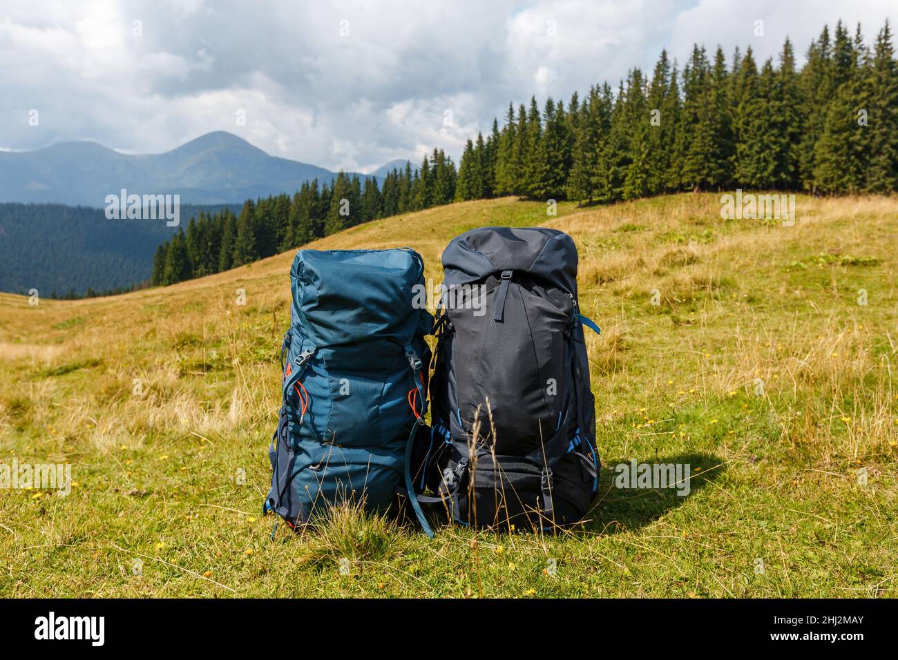 Two load backpacks standing on the background of beautiful mountain view. Couple of bags for trekking. Concept of active lifestyle, freedom and travel. Stock Photo