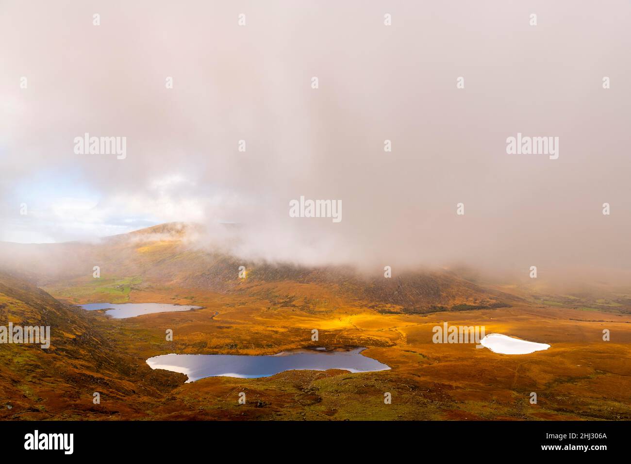 Autumn mountain landscape with small lakes and cloudy sky, Dingle Peninsula, Kerry, Ireland Stock Photo