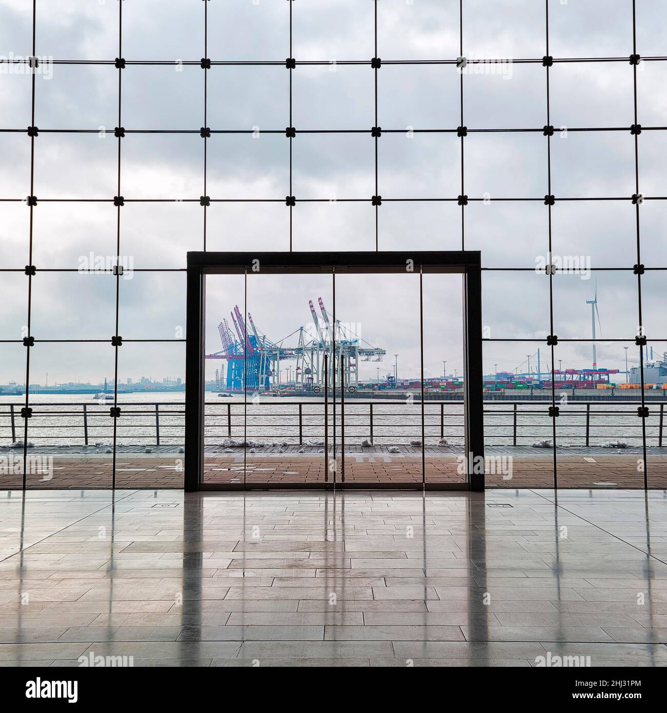 View through modern glass facade with large door onto the harbour, dreary winter weather, Holzhafen Ost office building, Astoc Architekten, Grosse Stock Photo