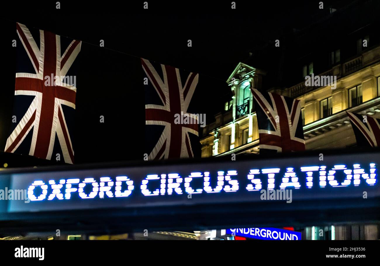 Oxford Circus Station sign in evening with flag of union jack Stock Photo