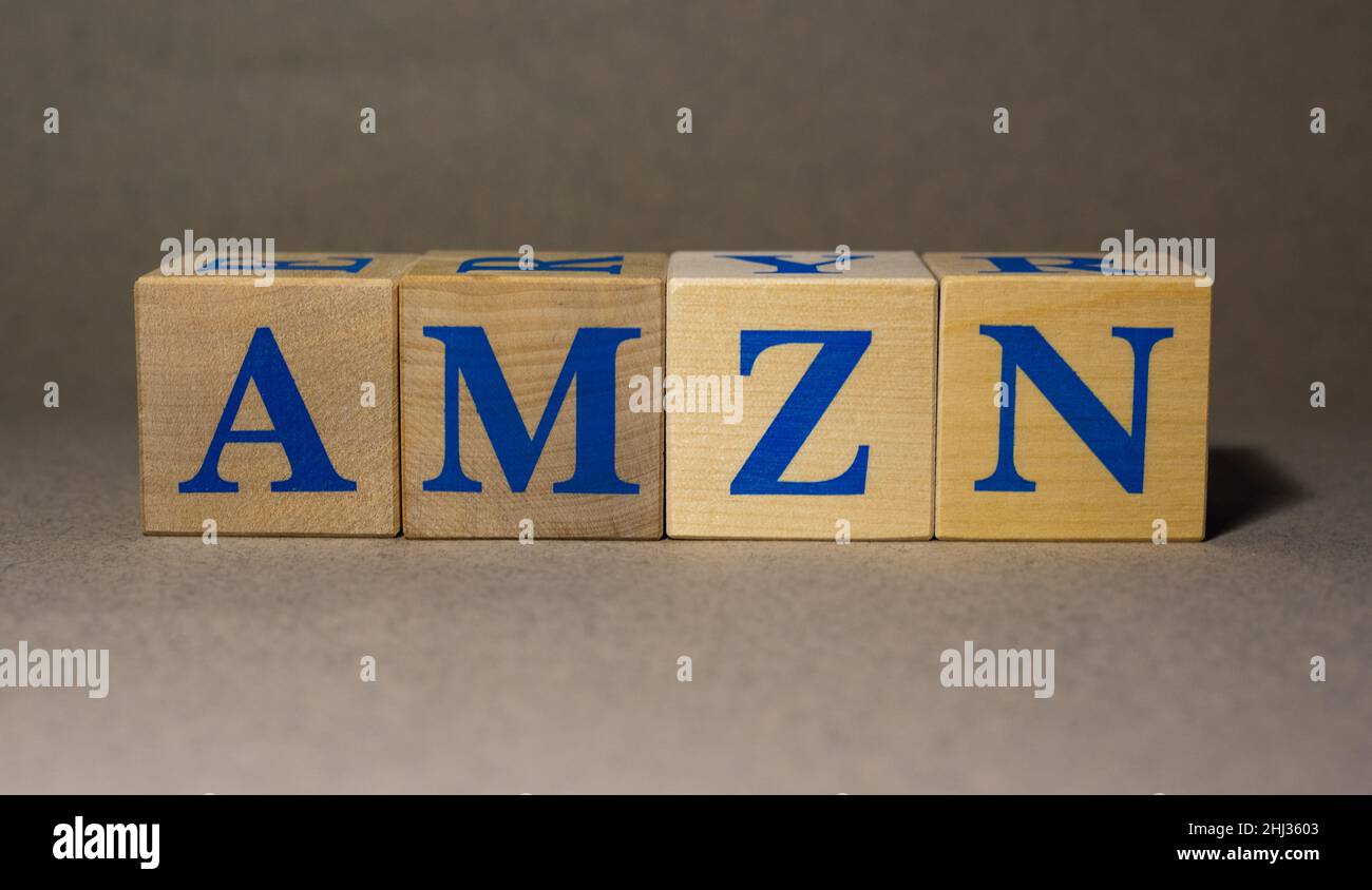 January 19, 2022. New York, USA. Stock ticker symbol from Amazon.com, Inc. AMZN, laid out from wooden cubes, on a gray background. Stock Photo