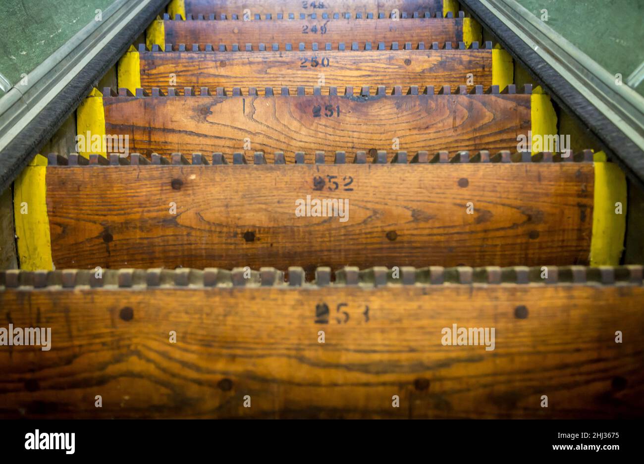 Old, wooden, numbered Escalator steps Stock Photo