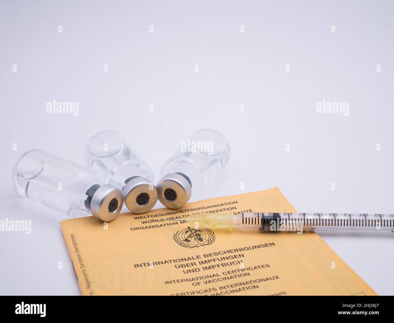 International vaccination certification with bottles of vaccine and syringe Stock Photo
