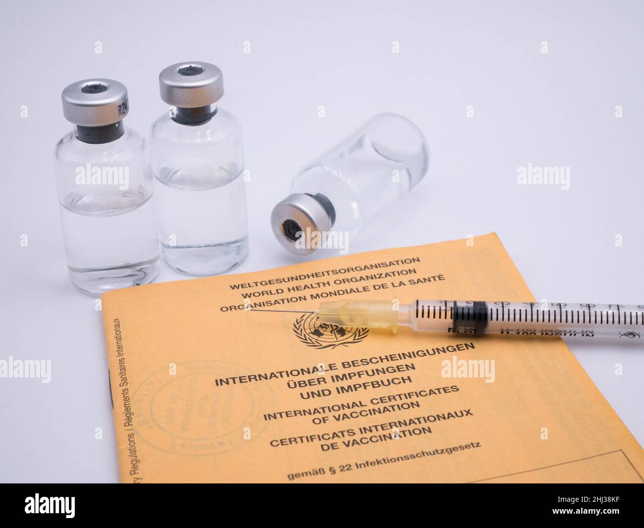 International vaccination certification with bottles of vaccine and syringe Stock Photo