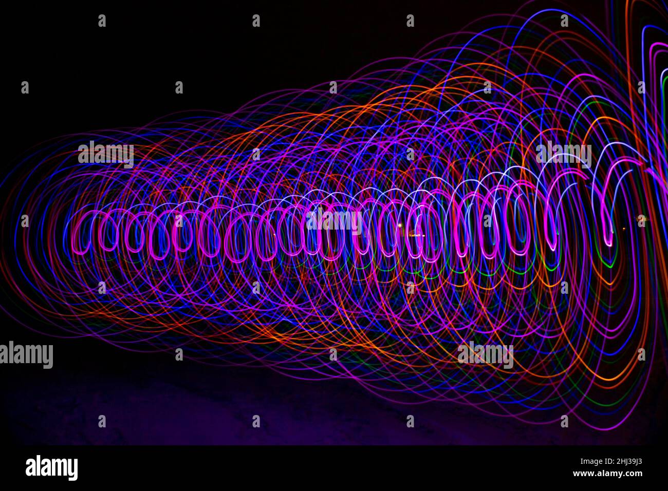 Multicolored spiral with light on a dark background. Stock Photo