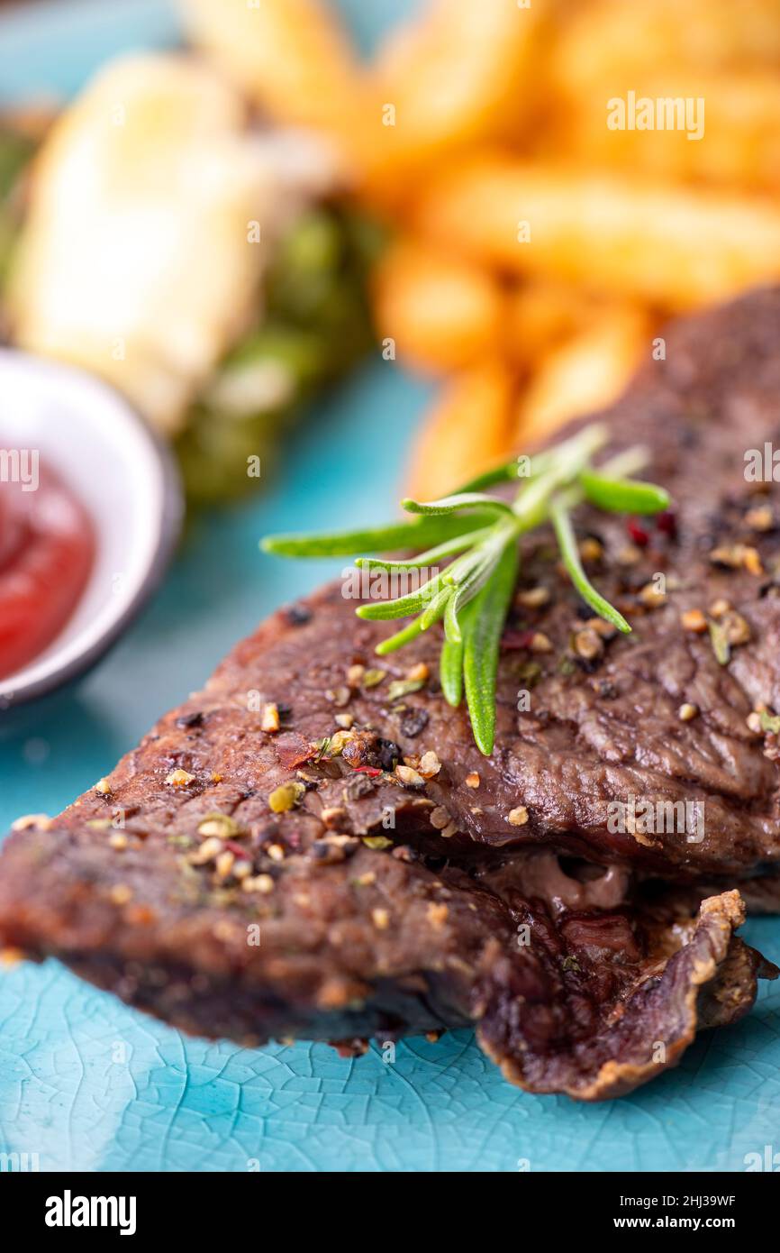 rosemary on a steak with fries Stock Photo Alamy