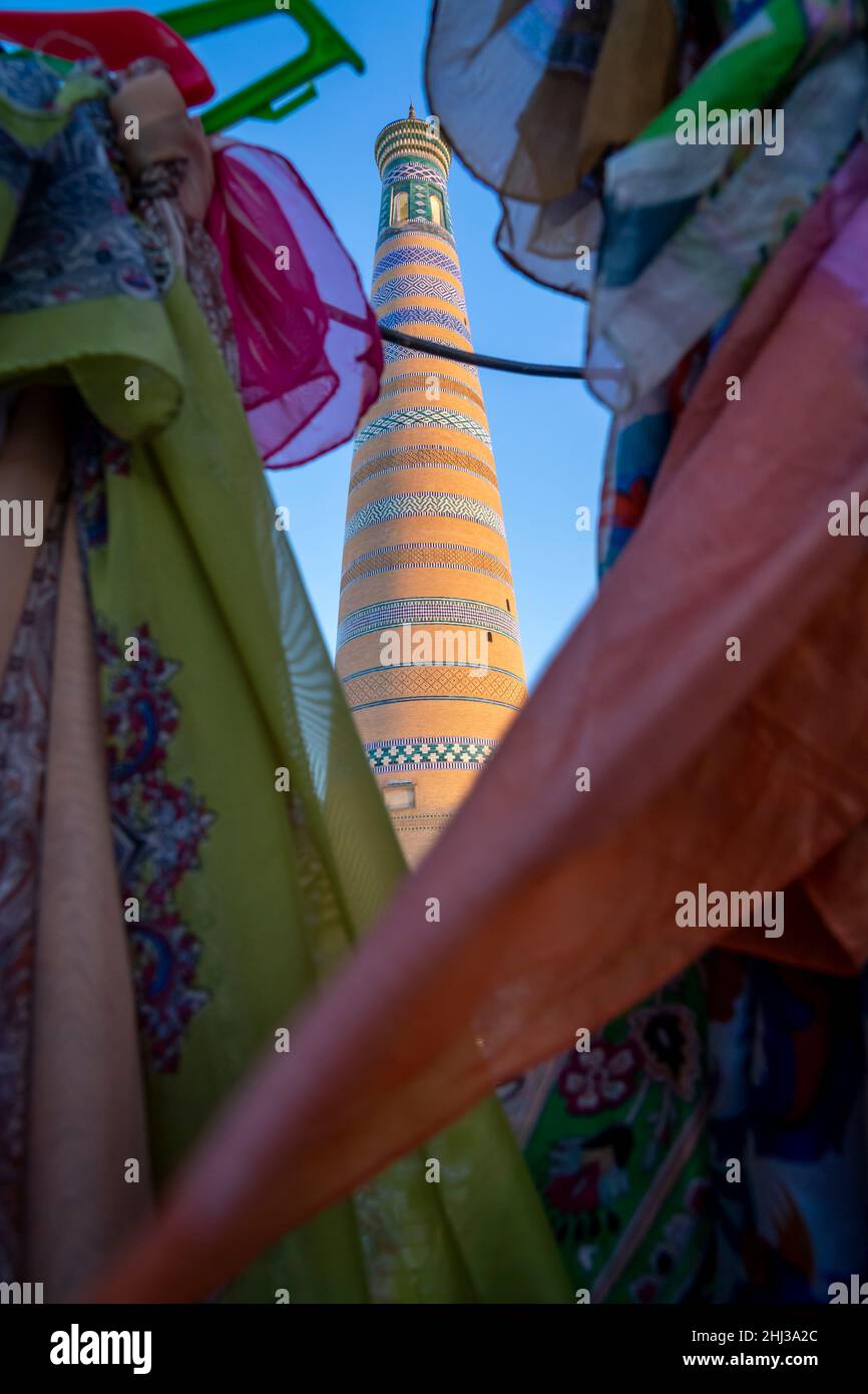 Islam Khoja Minaret through scarves in market stall Stock Photo