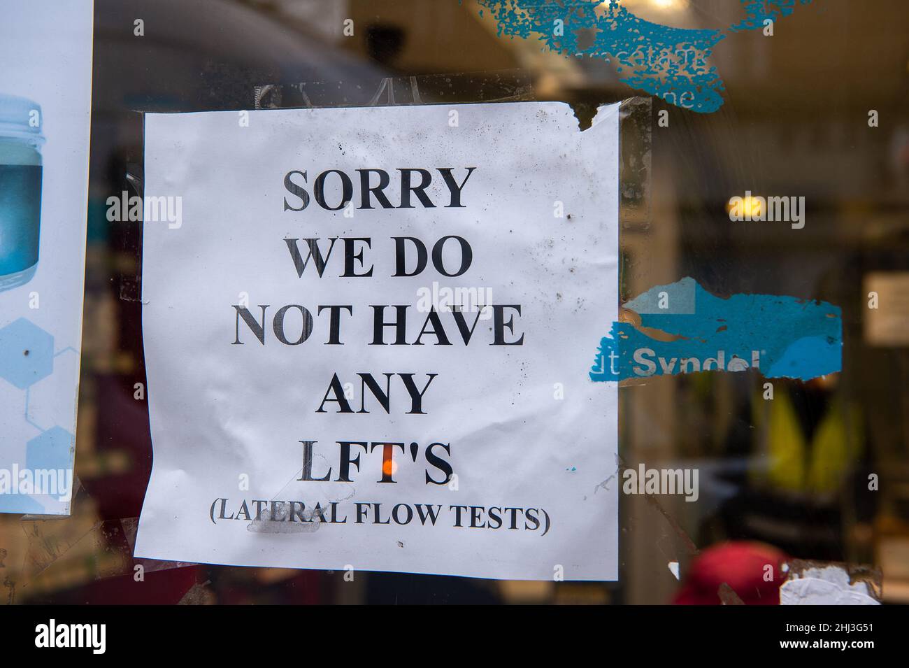 Weybridge, Surrey, UK. 26th January, 2022. A notice in a pharmacy window telling customers that they have no Covid-19 Lateral Flow Test packs available. Credit: Maureen McLean/Alamy Stock Photo